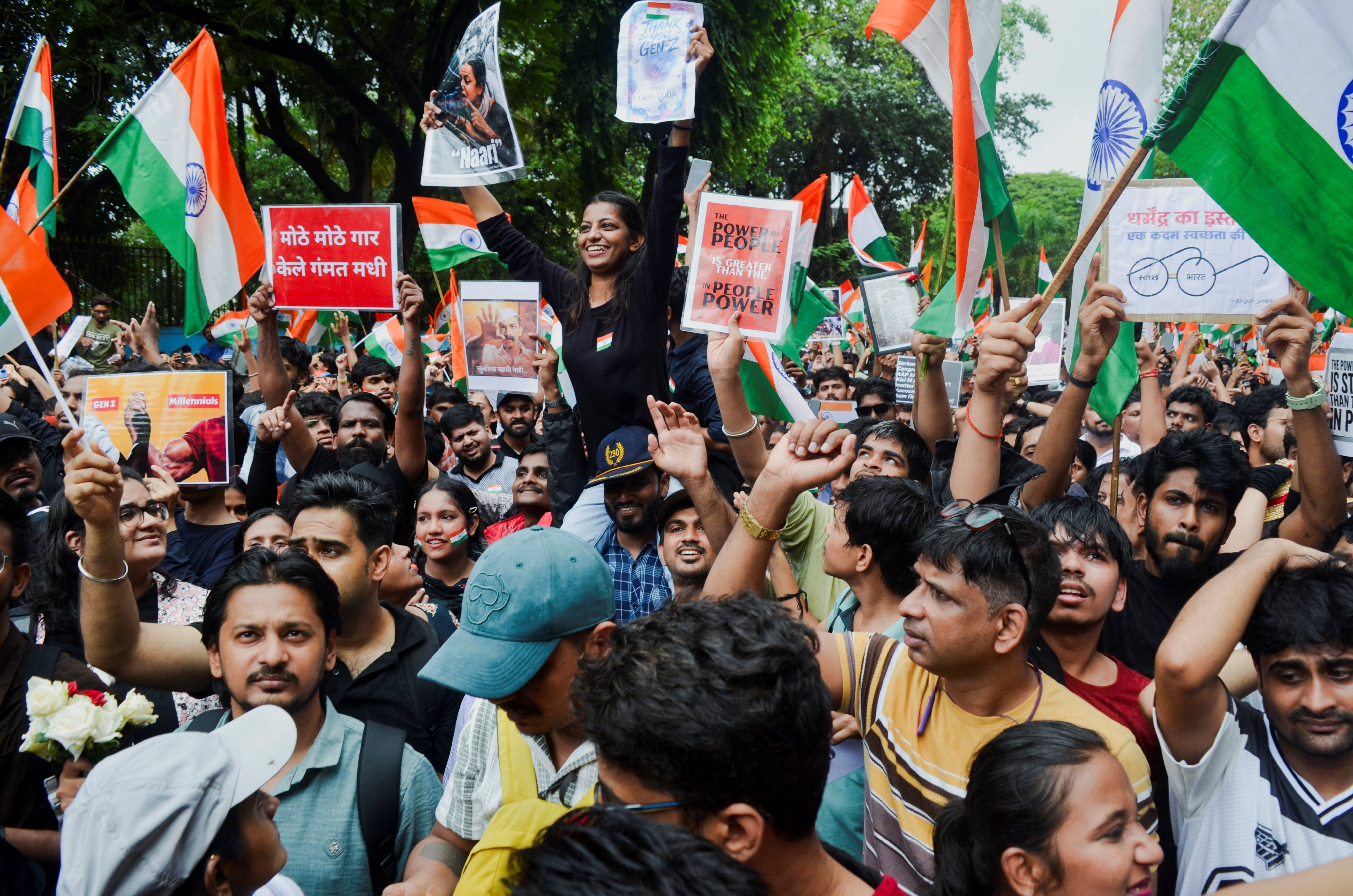 Cockroach Janta Party (CJP) supporters chant slogans, hold placards and wave national flag as they celebrate the resignation of Education Minister Dharmendra Pradhan over the National Eligibility cum Entrance Test (NEET) examination paper leaks, following a protest, in Mumbai, India, July 26, 2026. REUTERS/Indranil Aditya