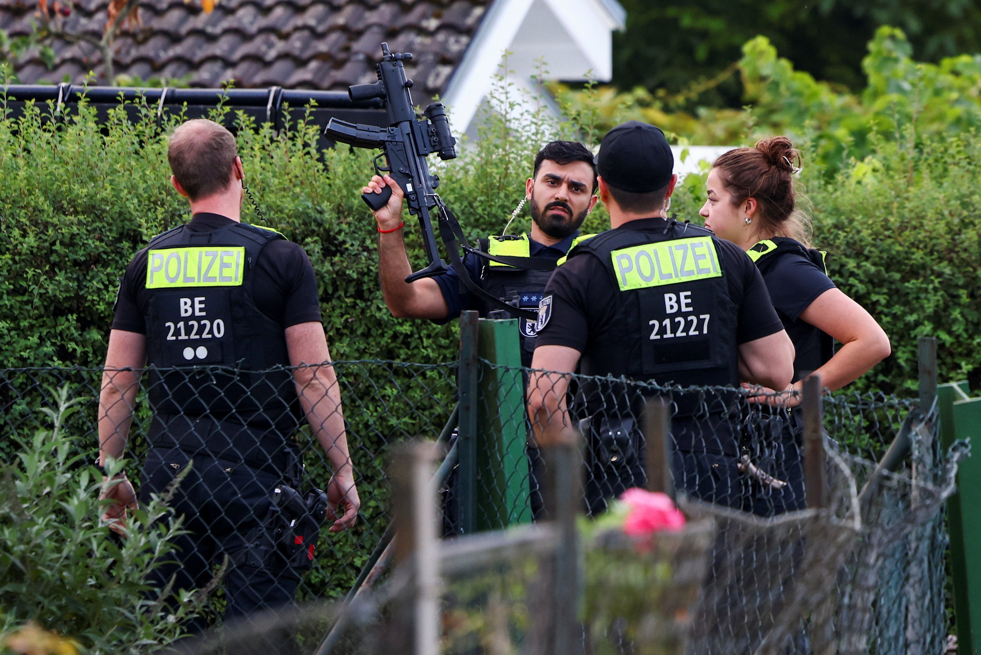 Police secure the area at an allotment garden complex in the Berlin suburb of Spandau after the suspect was shot dead. Photo: Reuters