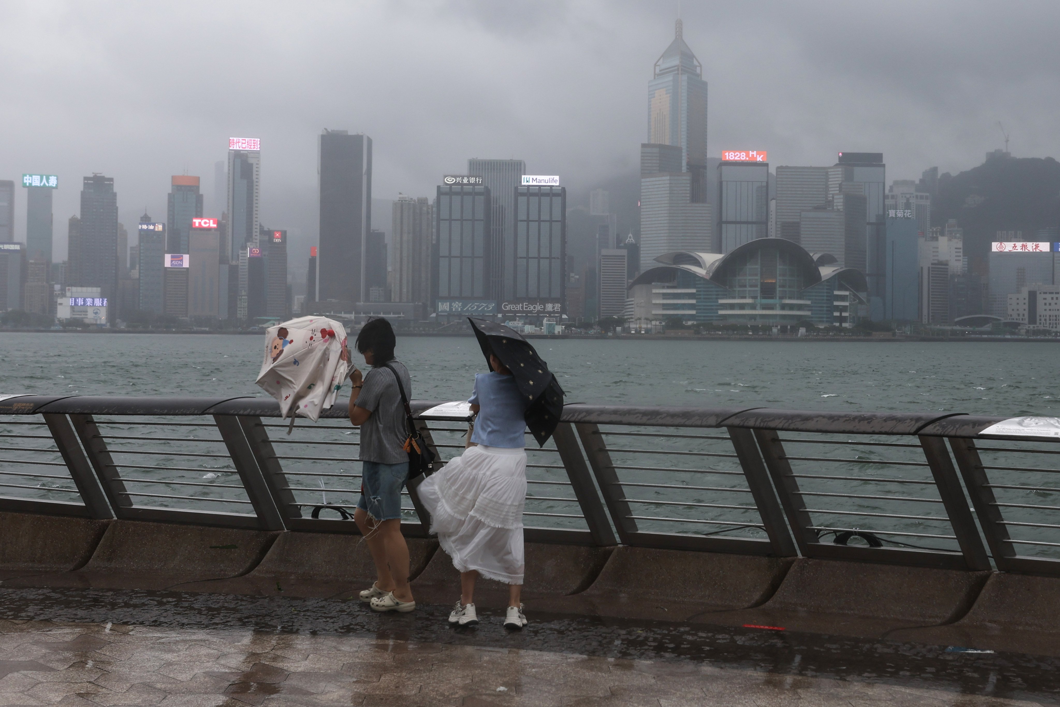 People endure strong winds and heavy rain in Tsim Sha Tsui on Sunday. Photo: Edmond So