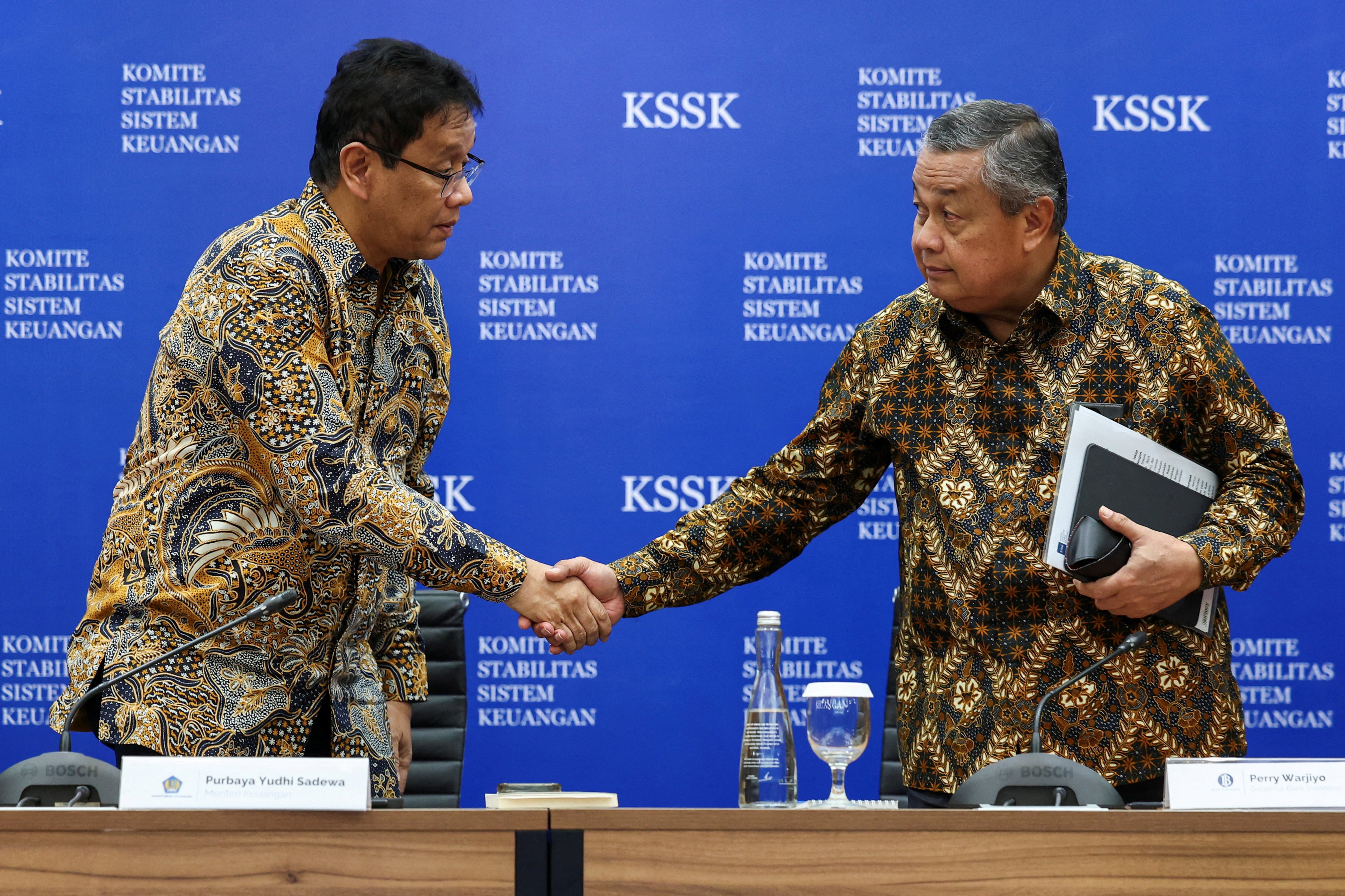 Indonesia’s Finance Minister Purbaya Yudhi Sadewa (left) shakes hands with then Indonesian central bank governor Perry Warjiyo following a press conference in Jakarta in November. Photo: Reuters