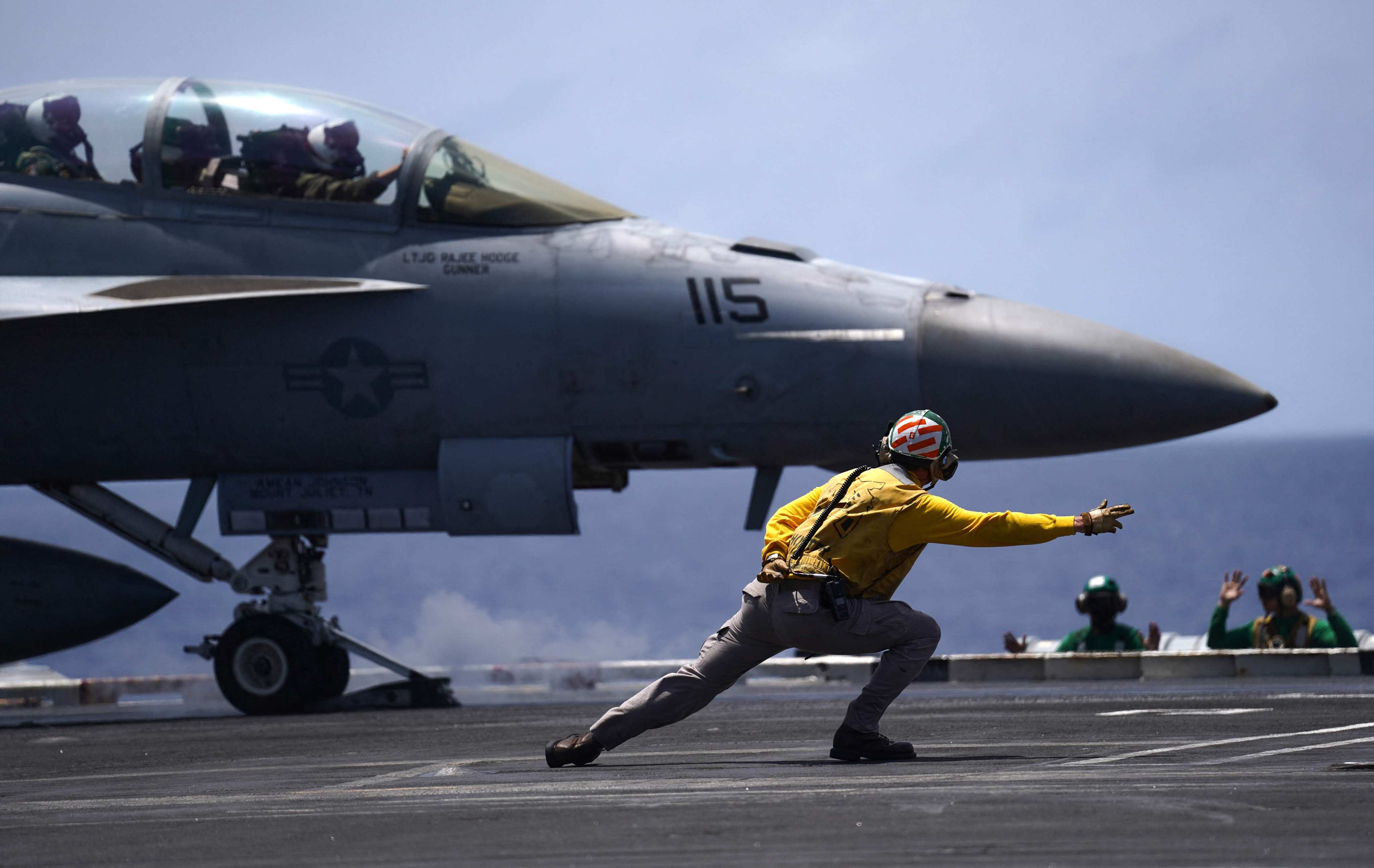 A US Navy F/A-18F Super Hornet gets into position on the flight deck of the USS Theodore Roosevelt during the Rimpac exercise on July 17. Photo: AFP