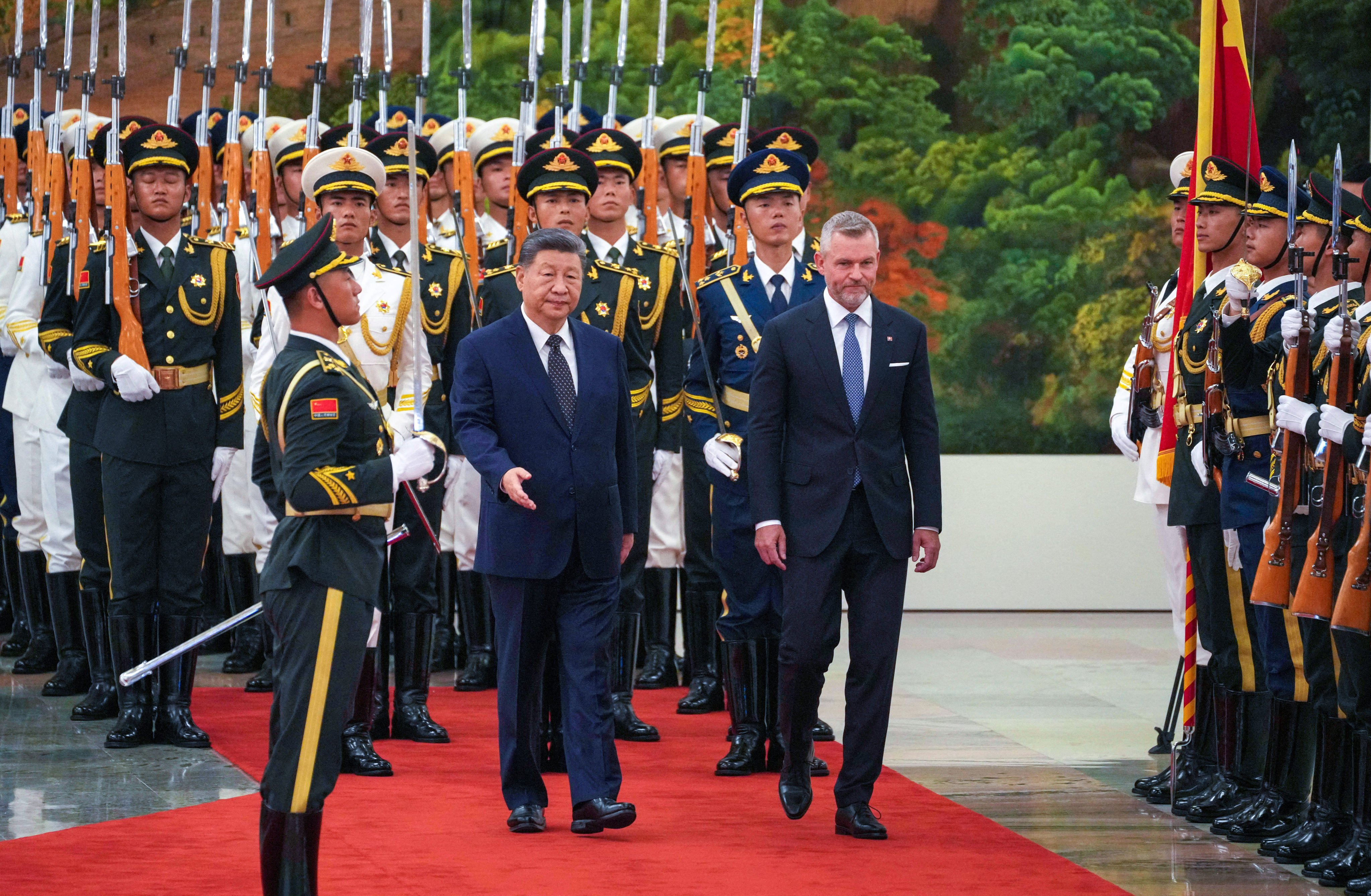 Chinese President Xi Jinping and Slovak President Peter Pellegrini inspect a guard of honor at the Great Hall of the People in Beijing on July 28. Photo: Reuters