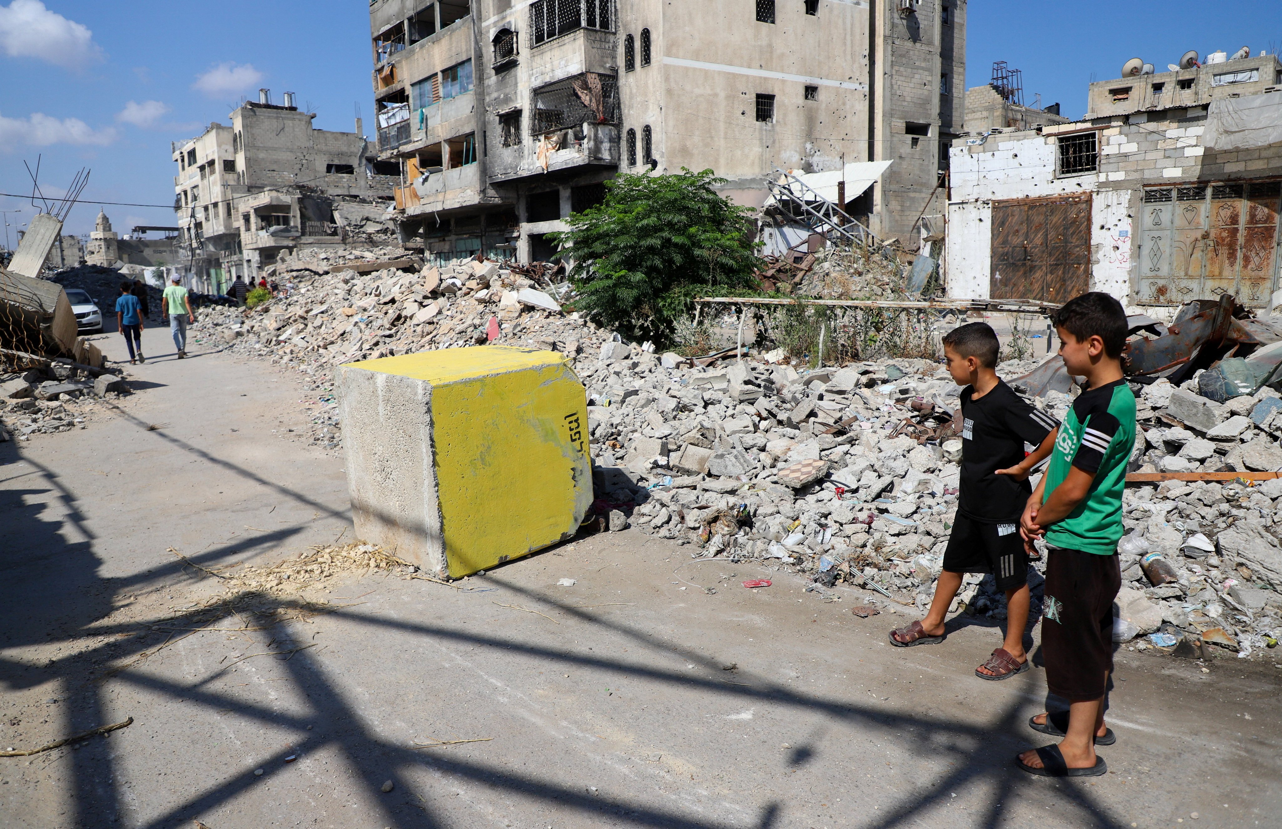 Palestinian boys look at a yellow concrete block marking the “yellow zone” under Israeli military control, in Tufah neighbourhood, in Gaza City on Monday. Photo: Reuters