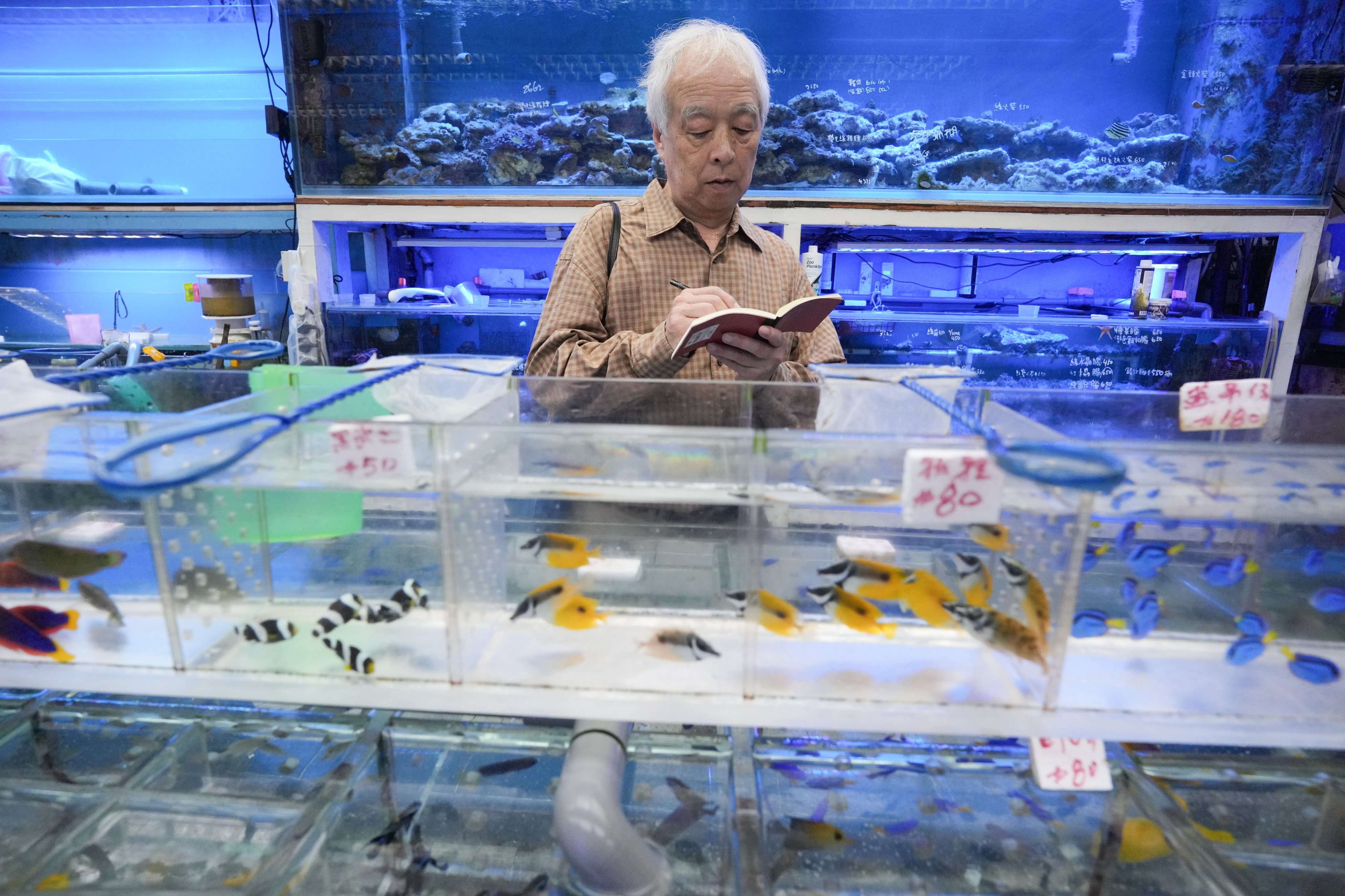 Shigeo Otake visits Tung Choi Street in Hong Kong’s Mong Kok area to do some sketching and get inspiration for future projects. The Japanese artist is currently having his solo debut Hong Kong exhibition at White Cube in Central. Photo: May Tse
