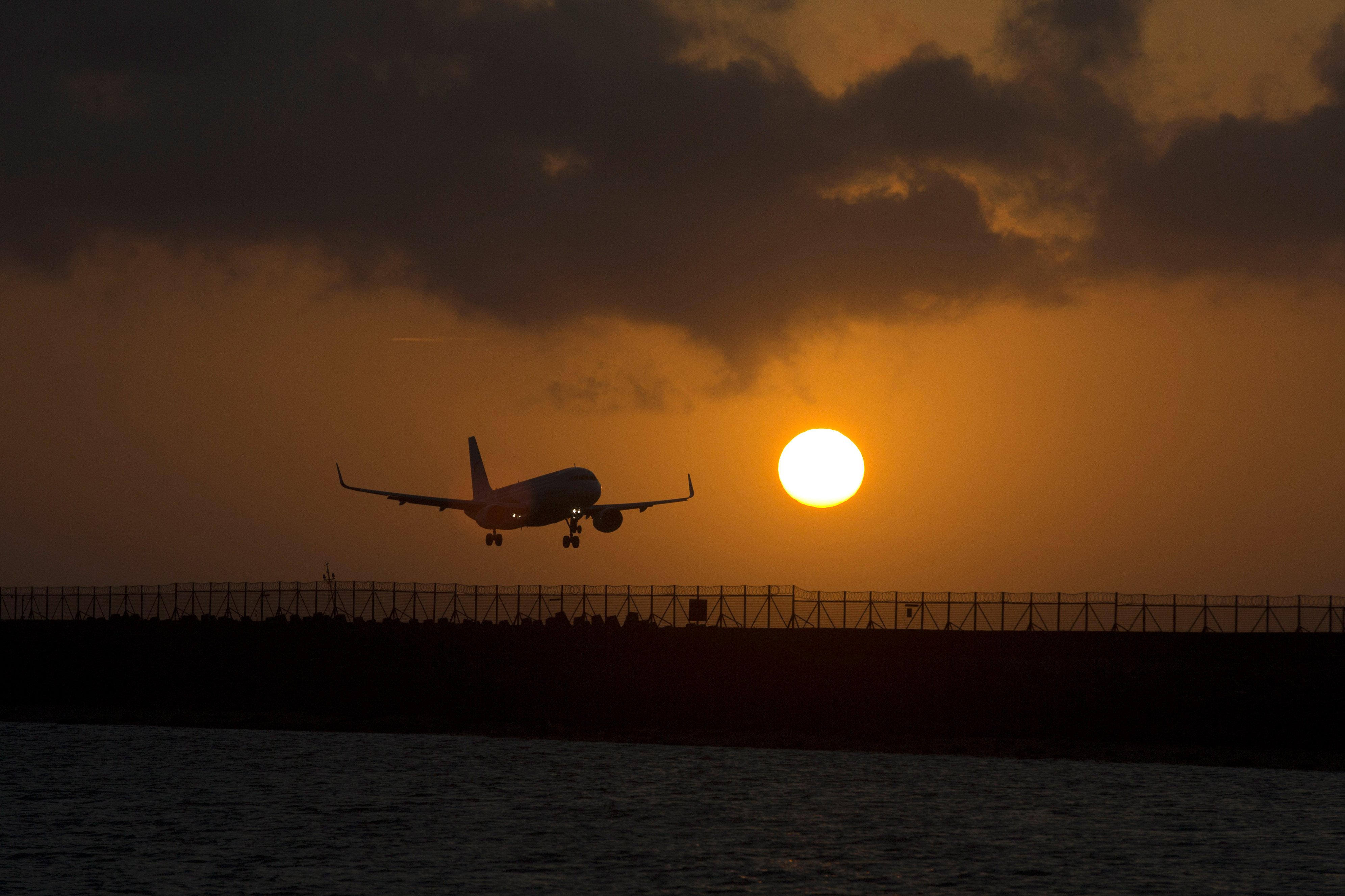 A passenger jet lands at I Gusti Ngurah Rai International Airport during sunset in Badung, Bali, Indonesia. Photo: AP