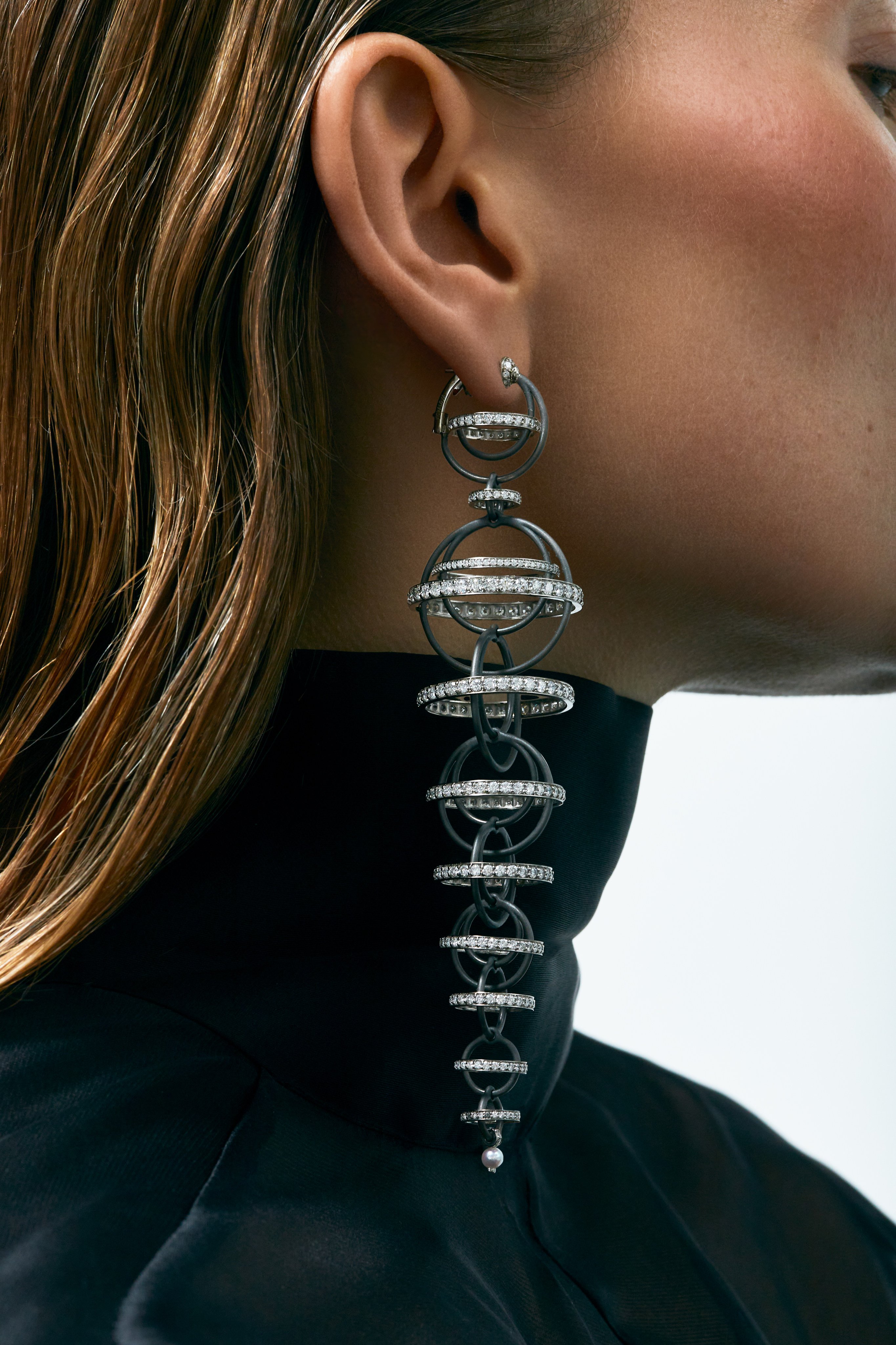 Flow earrings in titanium and 14k palladium gold, set with diamonds, blue sapphires and a pearl, by Inesa Kovalova. Photo: Handout