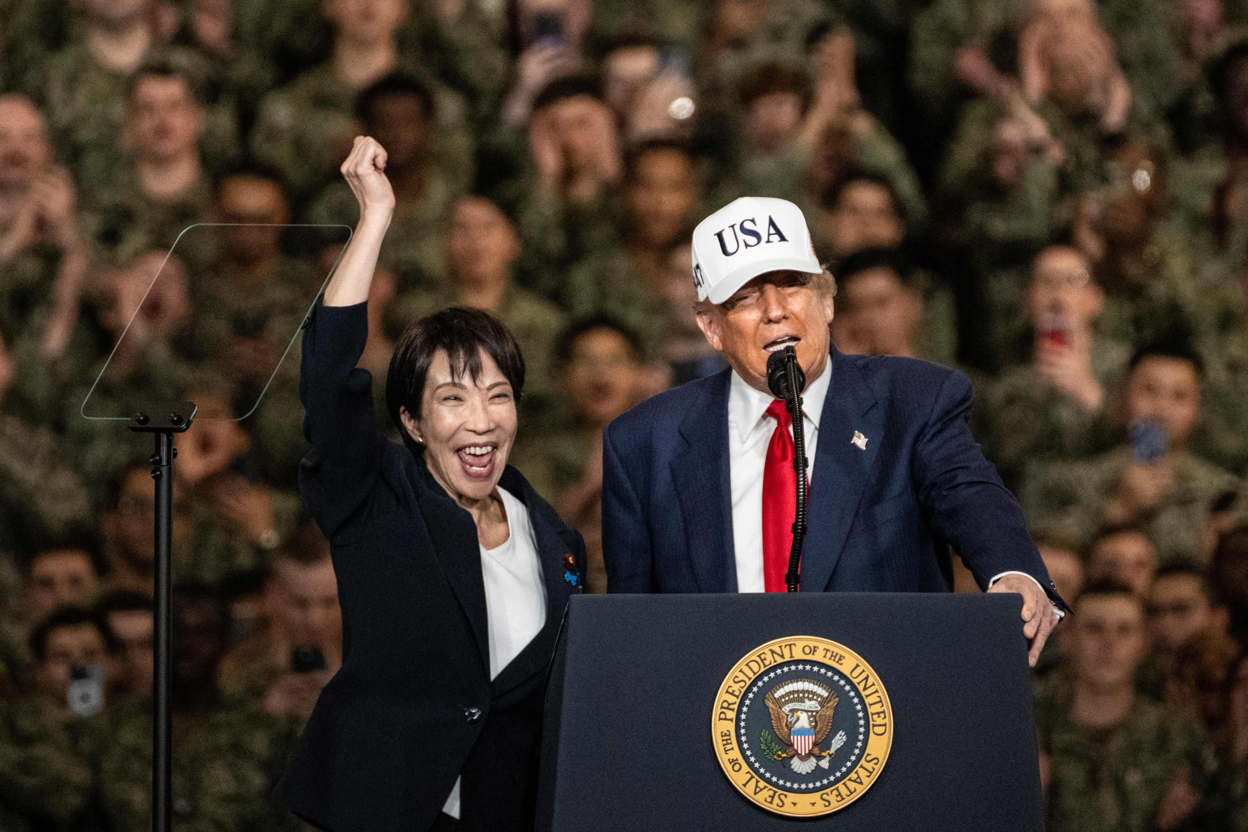Japan’s Prime Minister Sanae Takaichi (left) gestures as US President Donald Trump delivers a speech in front of US Navy personnel on board the US Navy’s USS George Washington aircraft carrier at the US naval base in Yokosuka, Japan, on October 28, 2025. Photo: AFP