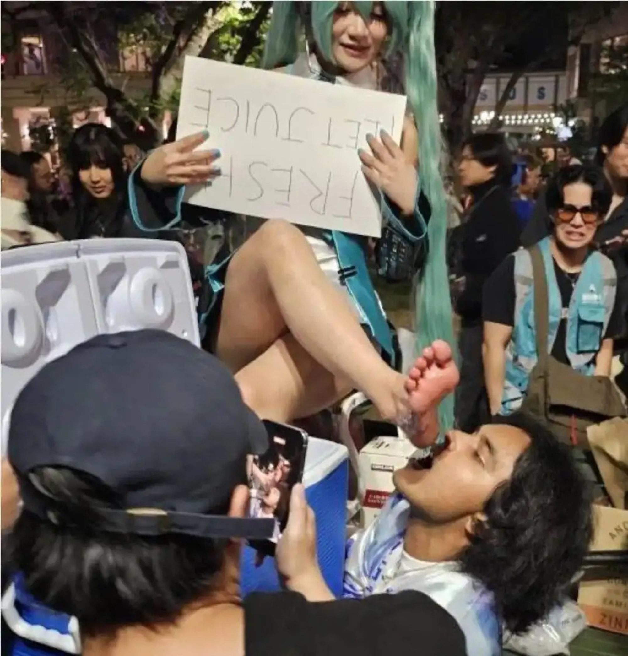 One convention attendee was captured kneeling with their mouth agape, attempting to catch drops of “feet juice” as they flowed from a cosplayer — an image that quickly went viral. Photo: Handout One convention attendee was captured kneeling with their mouth agape, attempting to catch drops of “feet juice” as they flowed from a cosplayer — an image that quickly went viral. Photo: Handout
