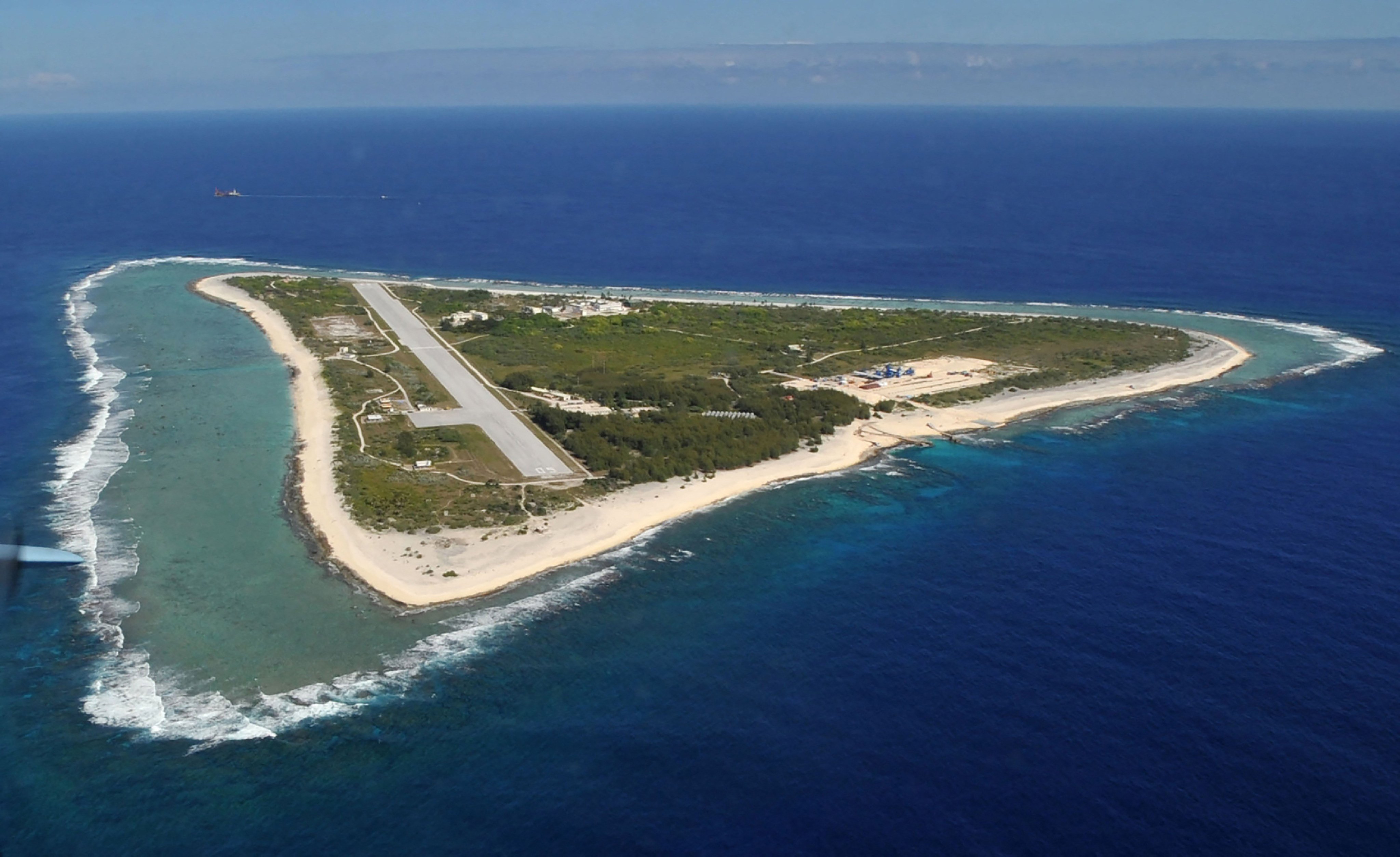 (FILES) This photo taken on November 21, 2012 shows an aerial view of Minamitorishima Island in Ogasawara Village, Tokyo Prefecture, where the government requested a literature survey regarding the selection of a final disposal site for high-level radioactive waste from nuclear power plants. Japan said on July 24, 2026 it plans to full-scale mining test in February for rare earth minerals from near a remote Pacific island, after a successful mission taking samples some six kilometres under the sea. Japan and the United States, as well as many other countries, are seeking to curb dependence on China for the valuable minerals used in an array of high-tech products from missiles to wind turbines. (Photo by JIJI PRESS / AFP) / Japan OUT