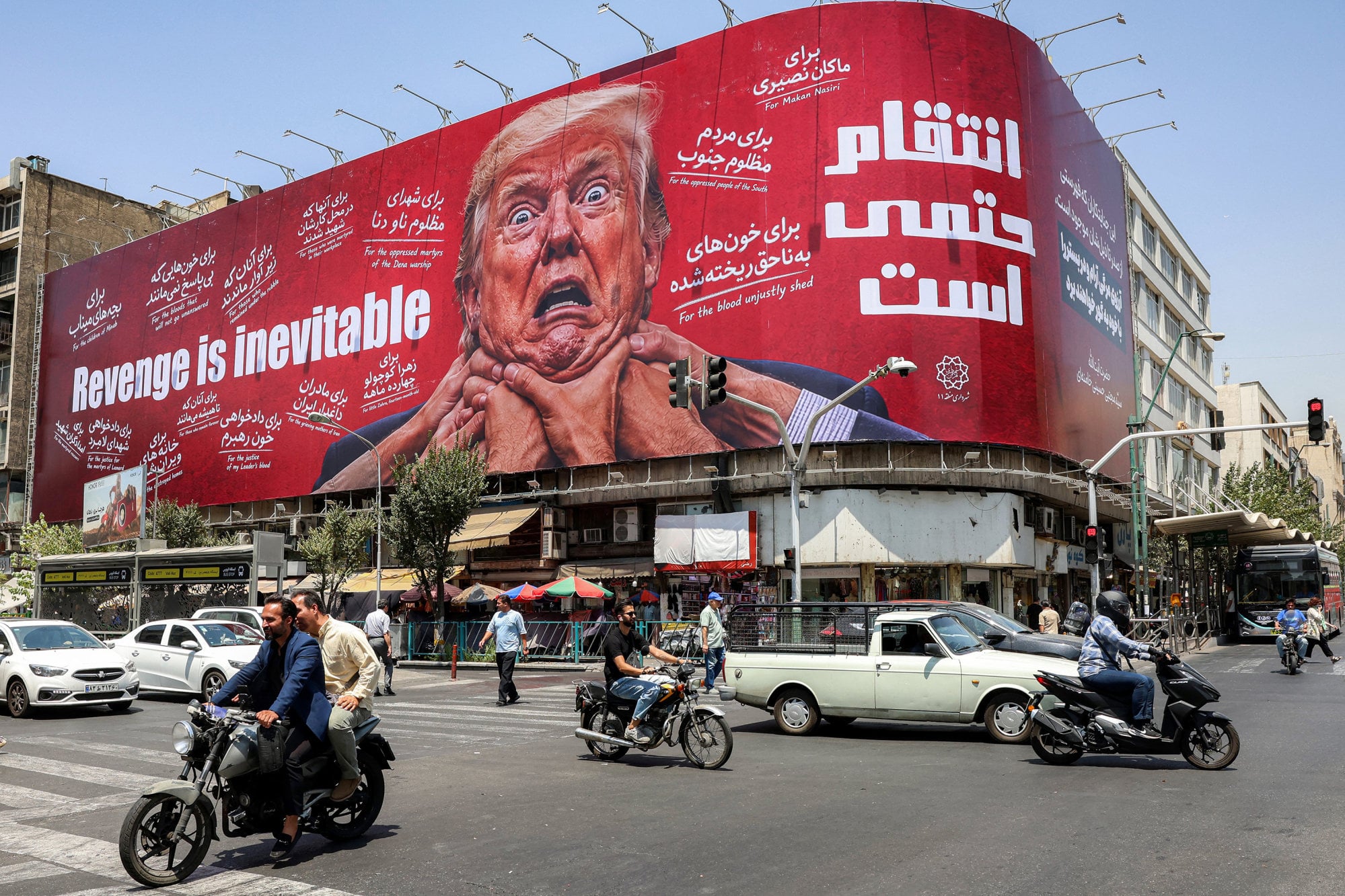Motorists drive past a large billboard pledging revenge against US President Donald Trump in central Tehran, Iran, on Monday. Photo: AFP/Getty Images/TNS