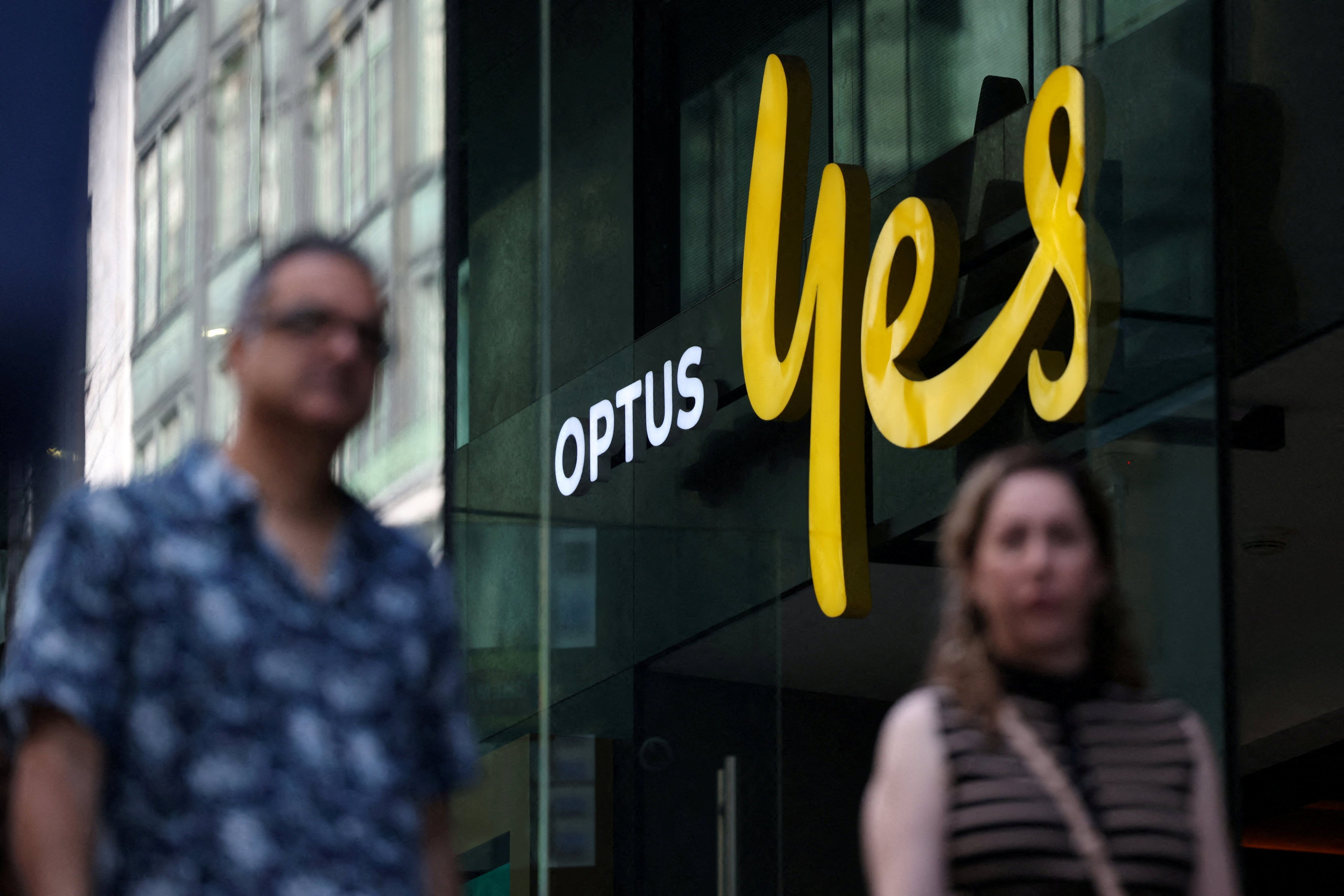 People walk past an Optus store in Sydney on September 29, 2025. Photo: Reuters