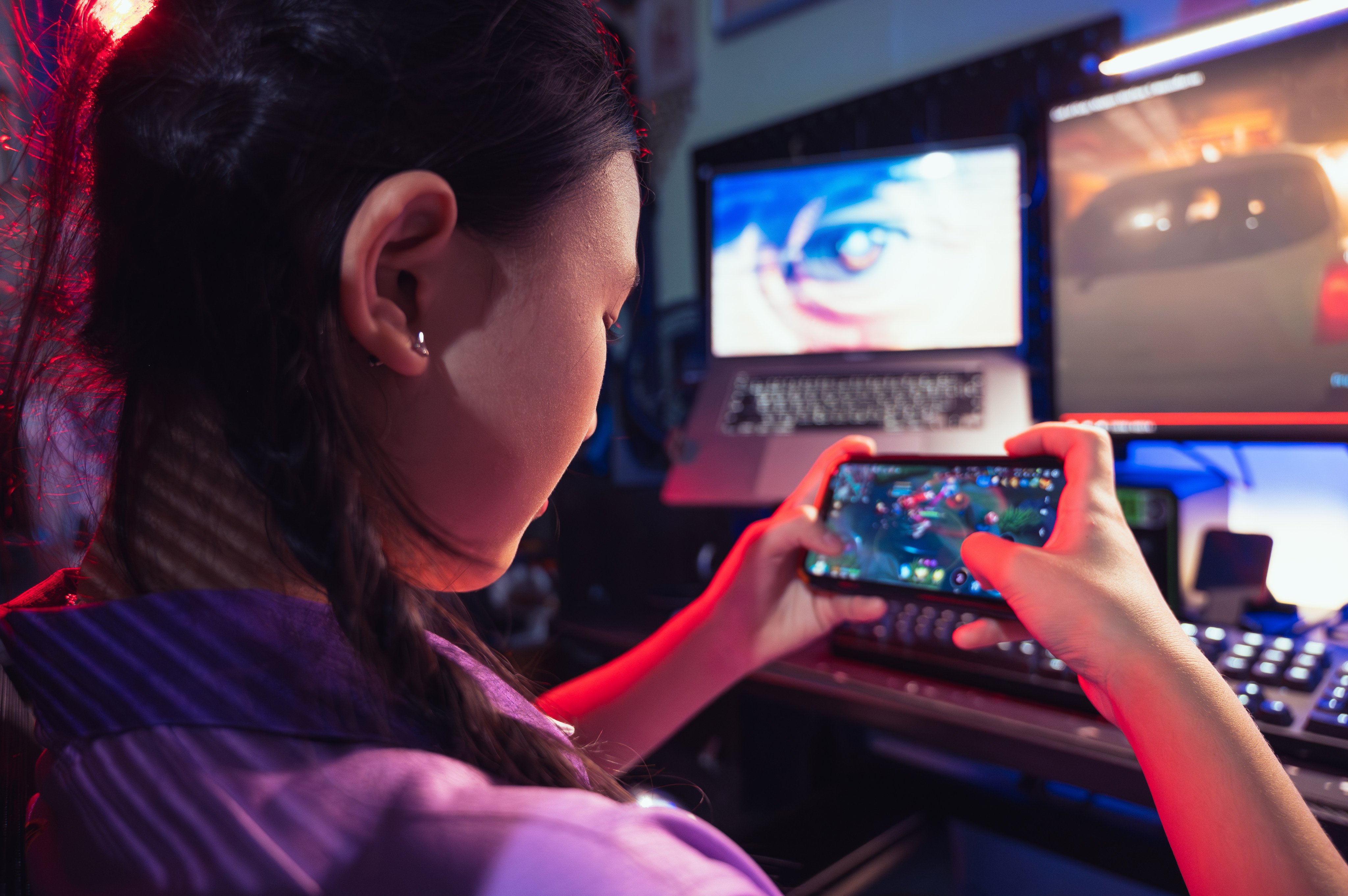 A teenager plays a mobile video game in an arcade. Photo: Getty Images
