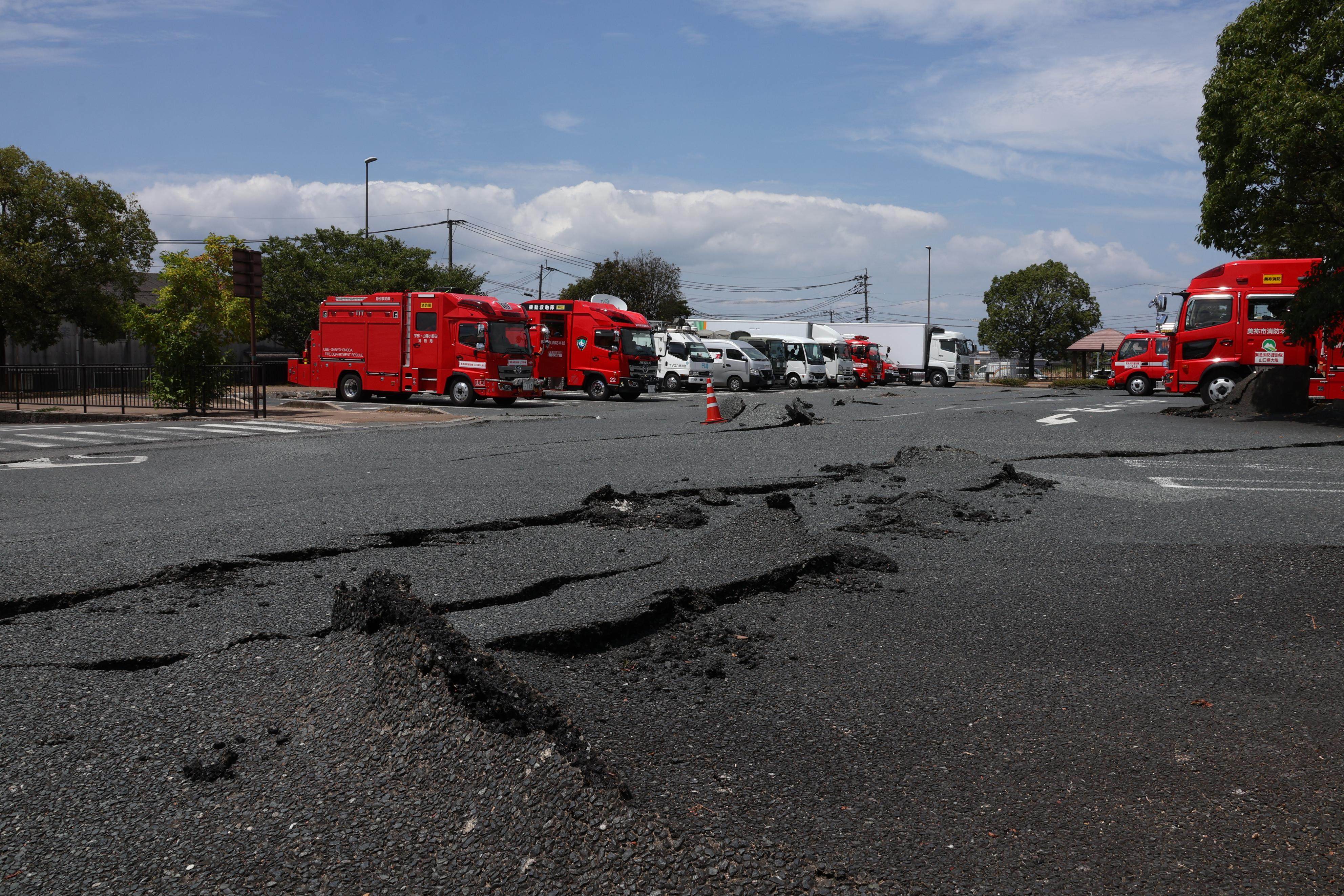 A road in Hikawa is buckled and cracked after Tuesday’s earthquake. Photo: Kyodo