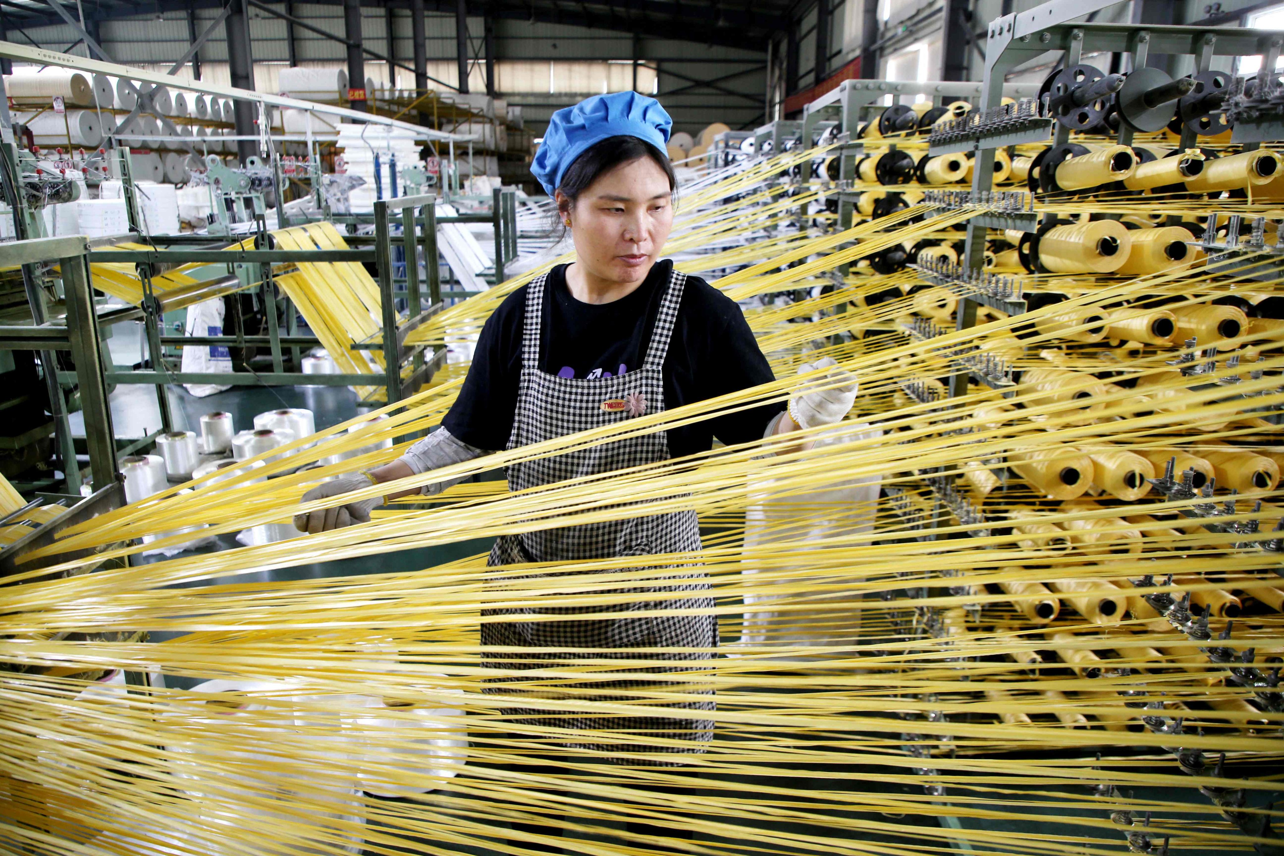 A worker monitors products for export at a packaging factory in Lianyungang, in China’s eastern Jiangsu province, on May 18. Photo: AFP
