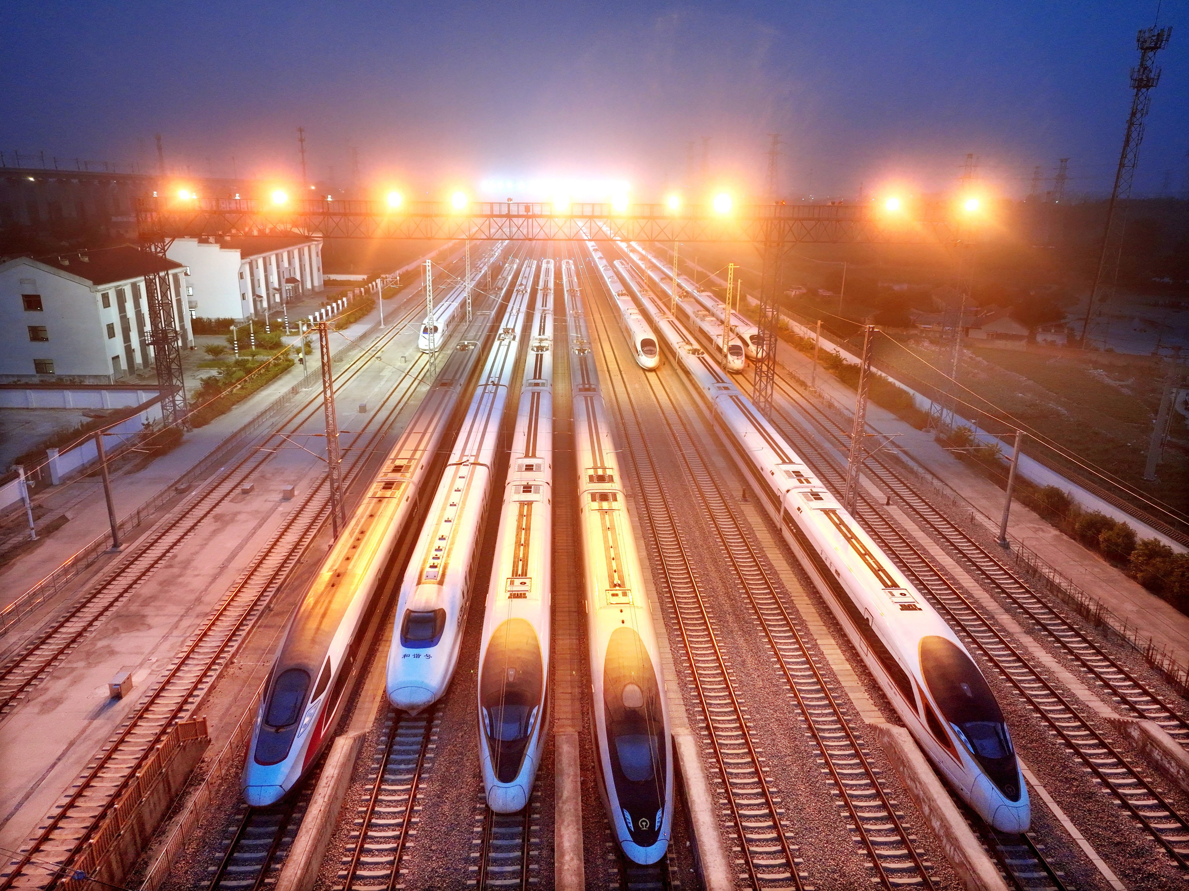 (260630) -- BEIJING, June 30, 2026 (Xinhua) -- A drone photo taken on June 30, 2026 shows high-speed trains stabled at a storage yard in Lianyungang, east China’s Jiangsu Province. Starting from 00:00 on July 1, China’s railway diagram will be adjusted by adding 106 passenger train services and 111 freight train service to the current schedule. After the adjustment, a total of 12,174 passenger trains will be scheduled nationwide, while 23,975 freight trains will be operated. (Photo by Wang Chun/Xinhua)