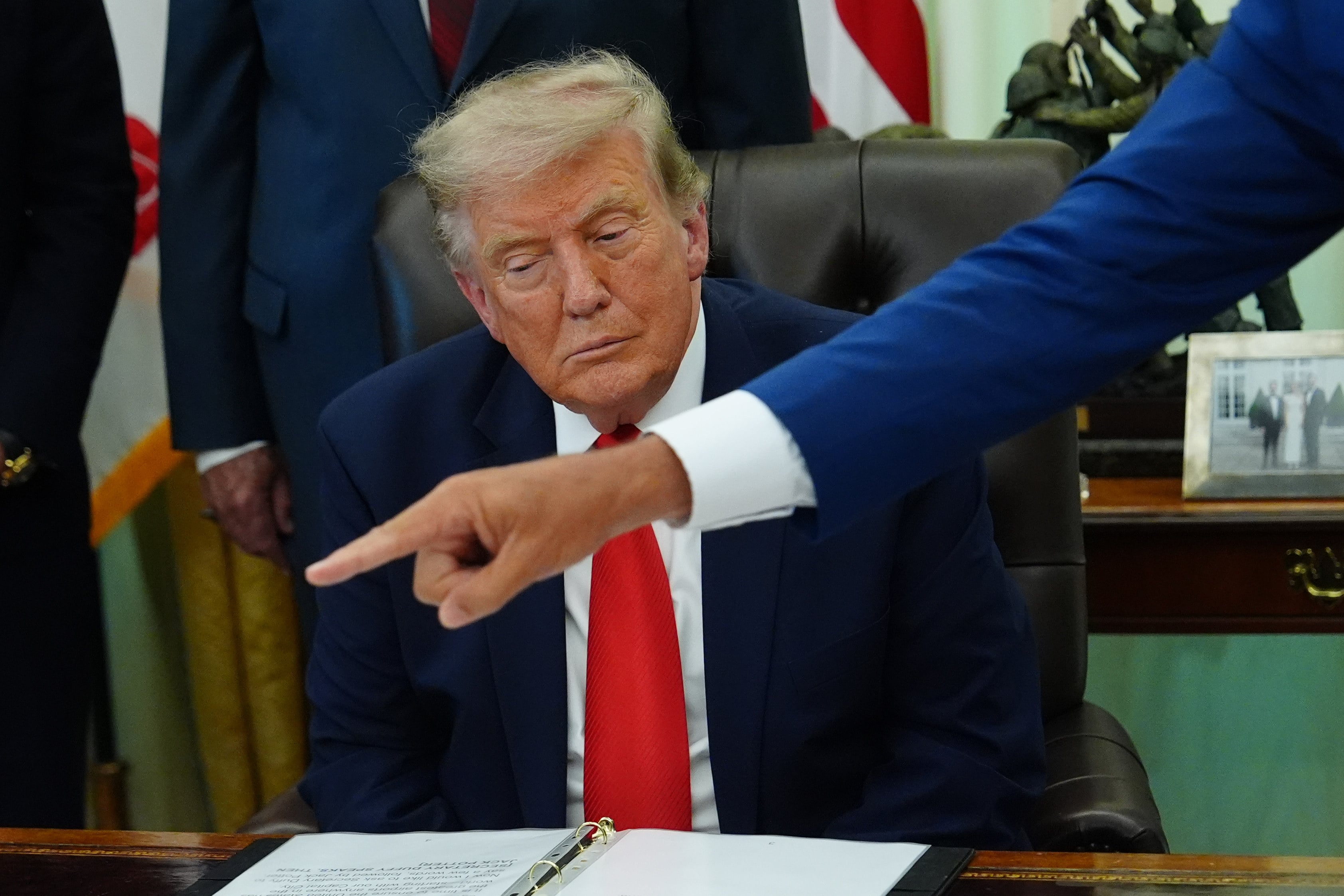 US President Donald Trump listens in the Oval Office of the White House on July 29. Photo: AP