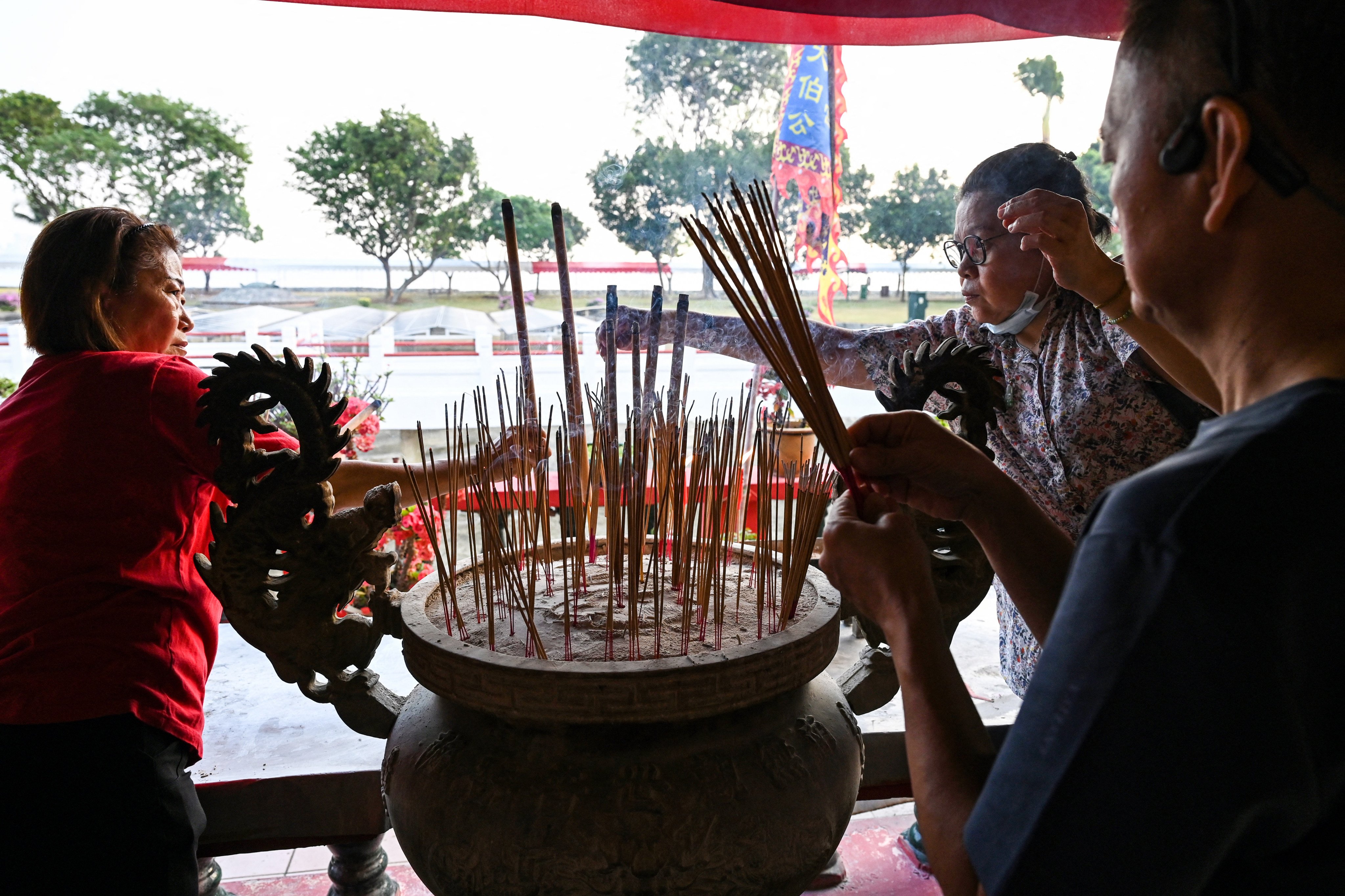 Devotees burn incense at a Taoist temple with Buddhist elements on Singapore’s Kusu island in 2023. Photo: AFP