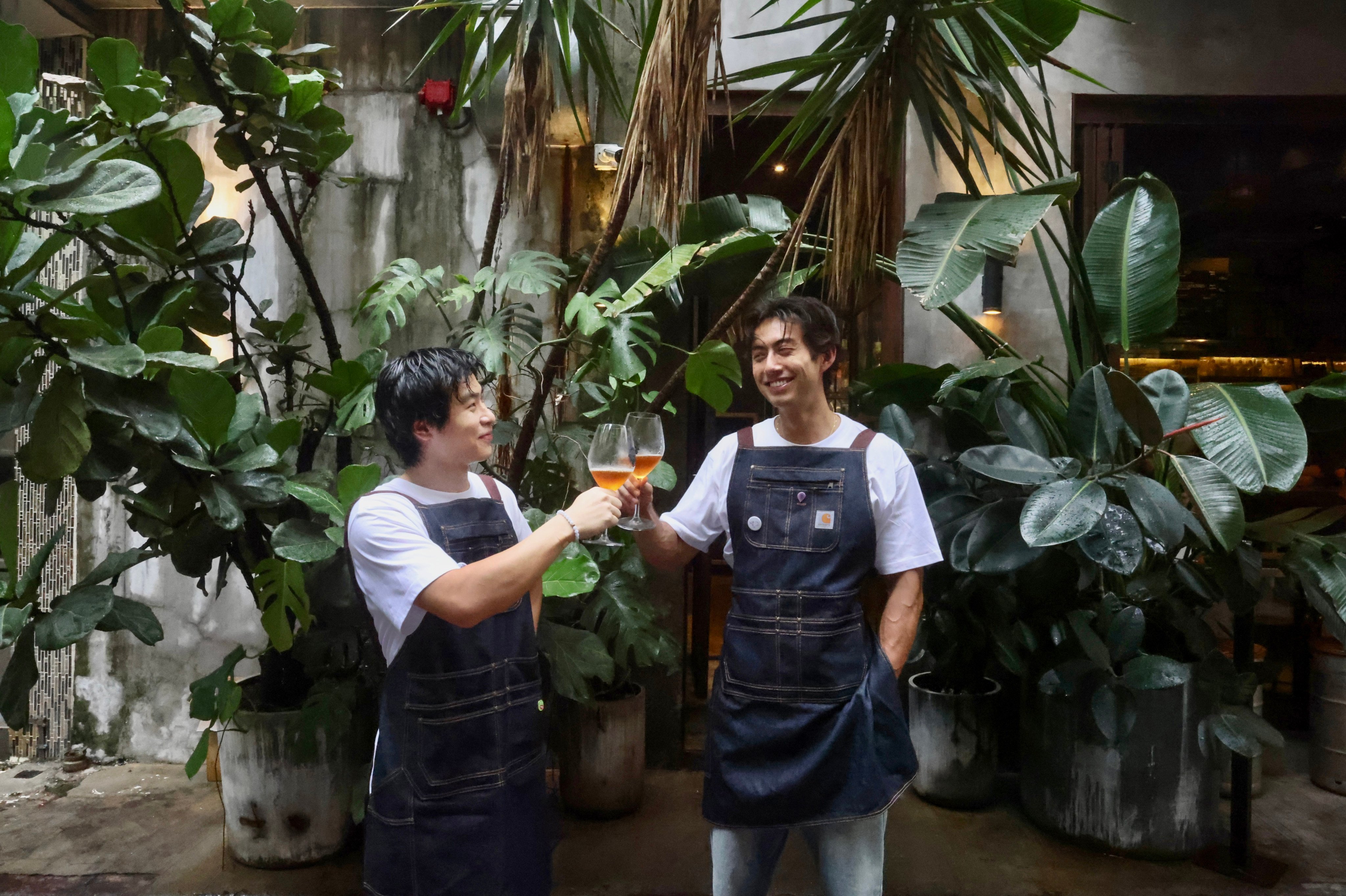 Purple Rain Wine founders Anson Sik (left) and Edson Bichon make a toast. The Gen Z entrepreneurs founded their company to bring Chinese natural wines to drinkers in Hong Kong, and to tell the stories behind the bottles. Photo: Jonathan Wong