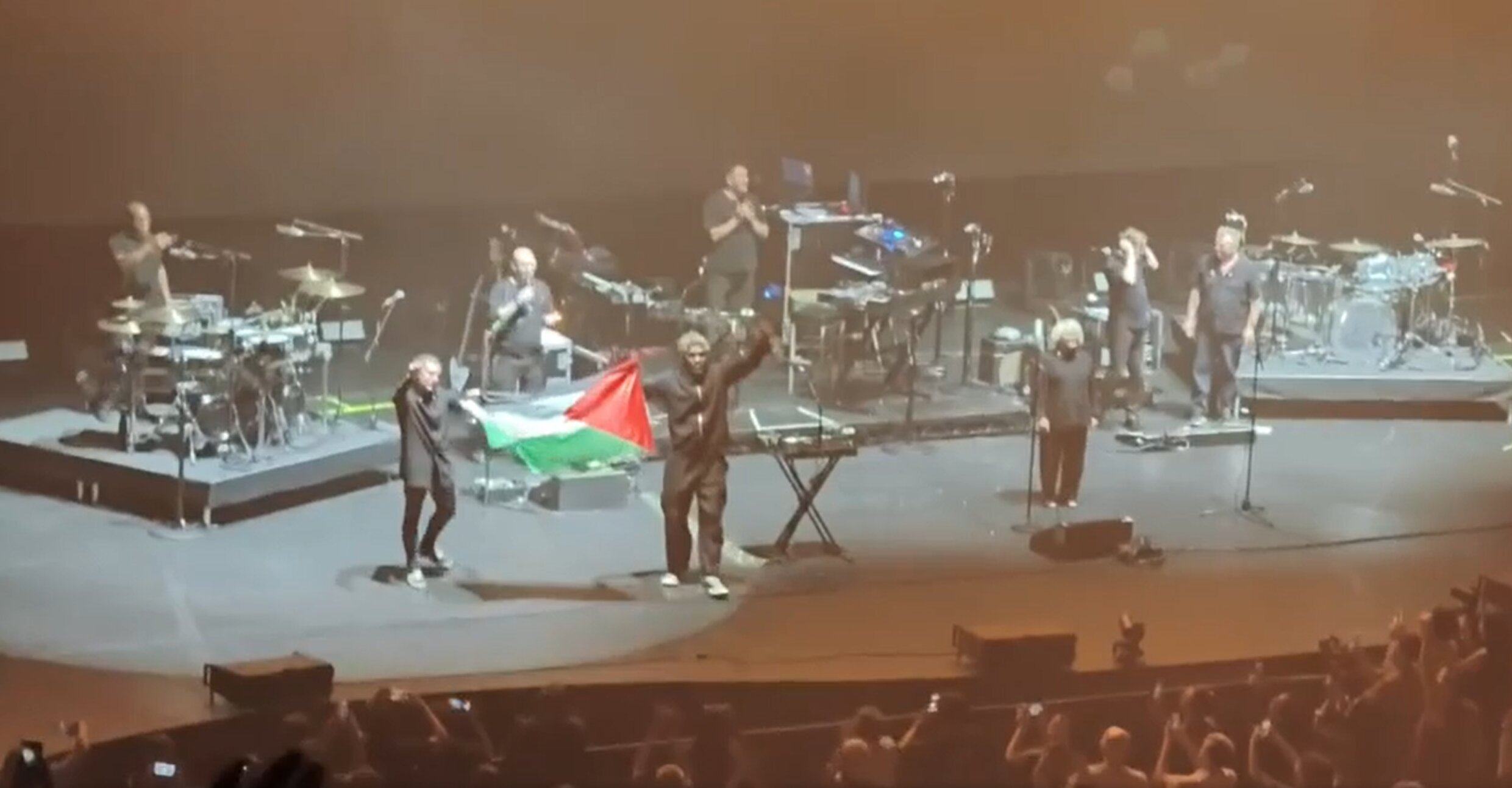 Two members of Massive Attack hold up a Palestinian flag during its concert in Singapore on Wednesday. Photo: Reddit/blushie157