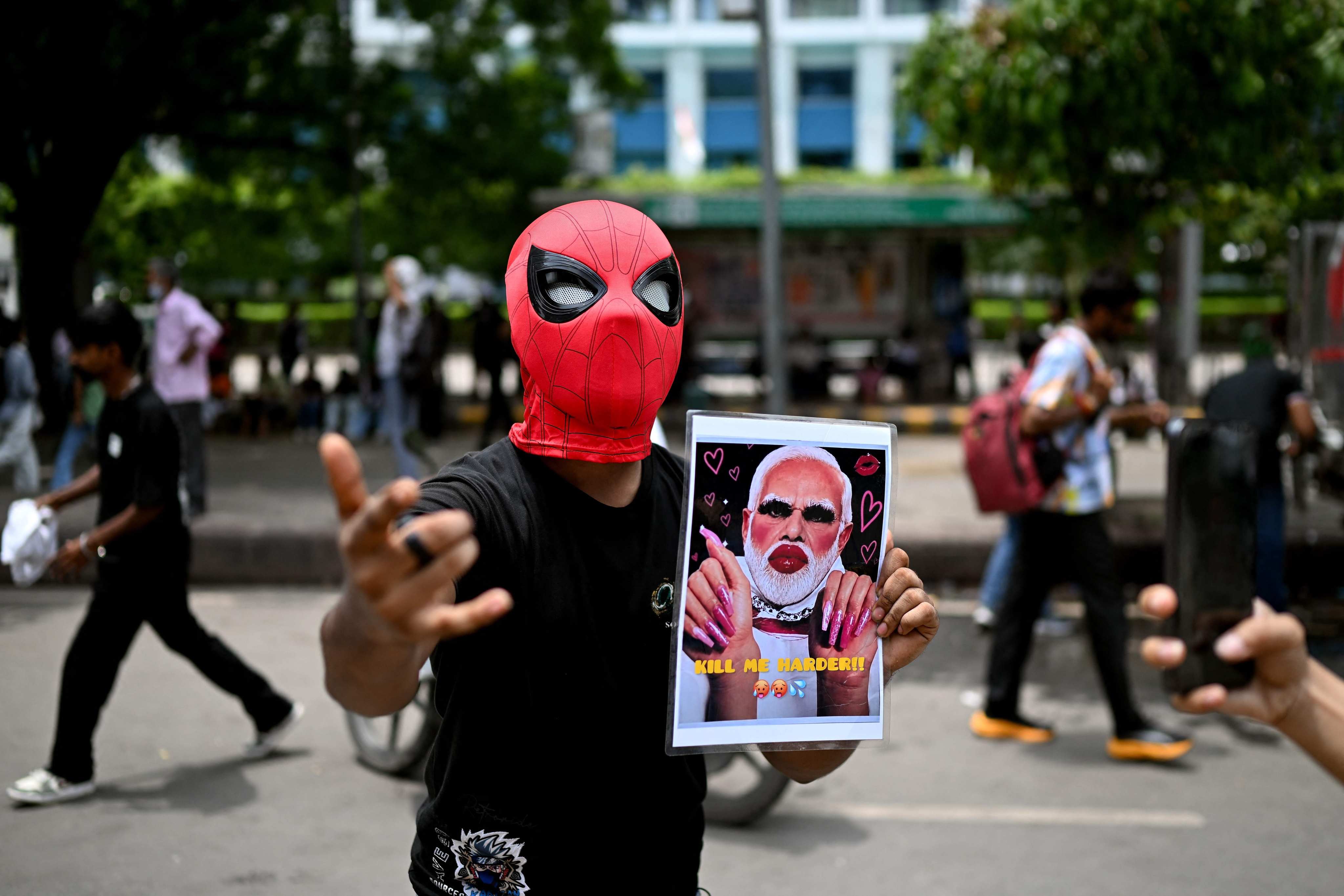 A CJP supporter holds a poster showing an altered image of Prime Minister Narendra Modi in New Delhi on July 25. Photo: AFP