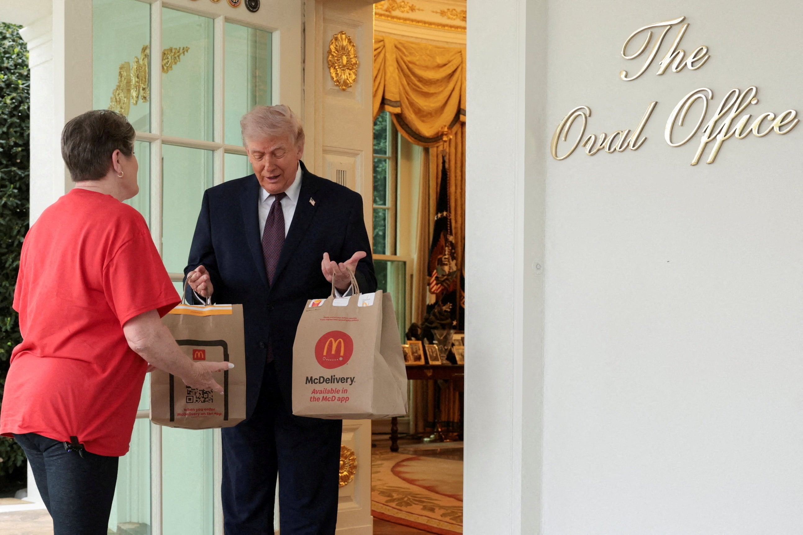 US President Donald Trump receives a McDonald’s delivery via DoorDash outside the  White House in Washington on April 13. Photo: Reuters