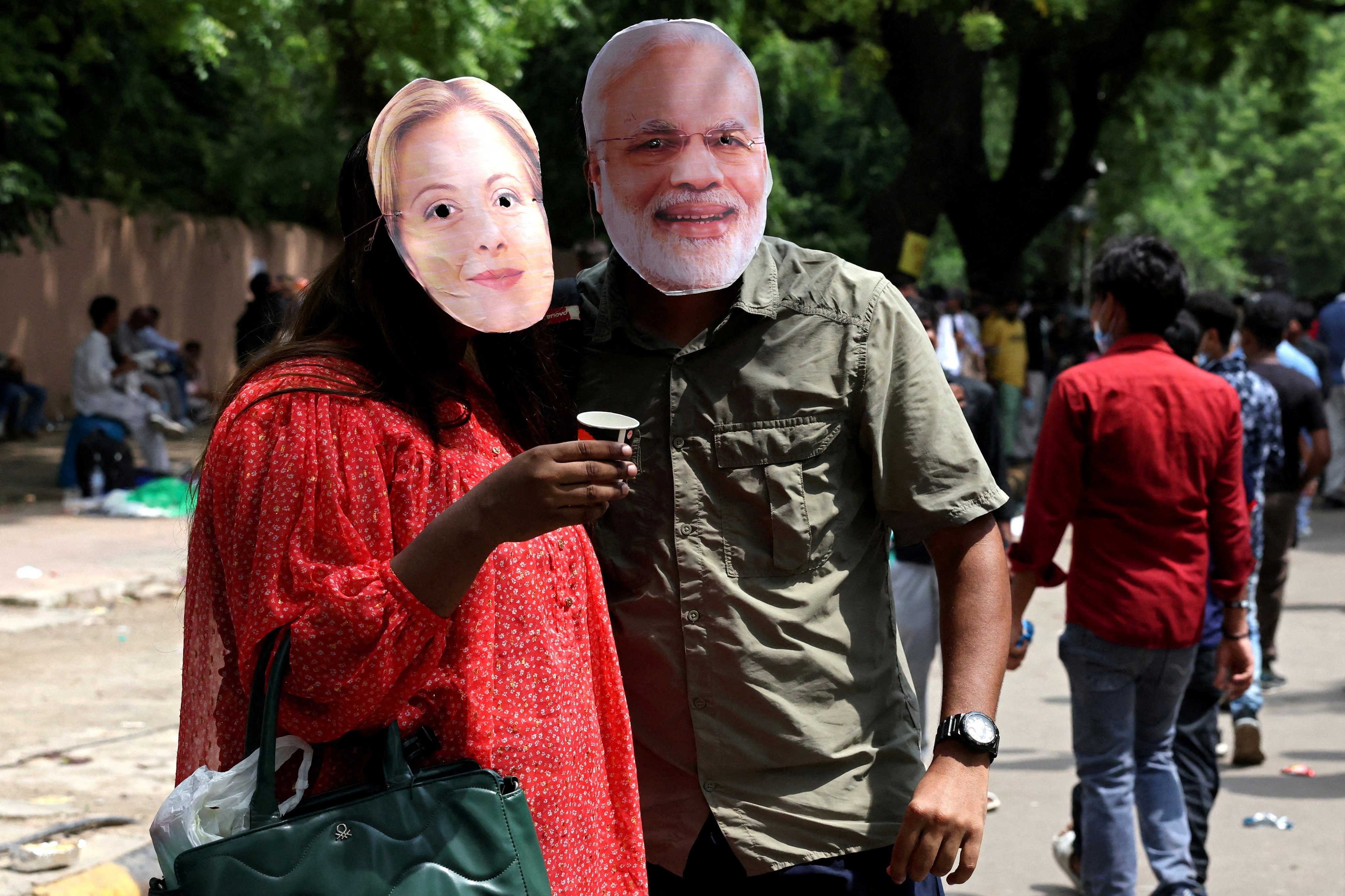 CJP supporters wear masks of India’s Prime Minister Narendra Modi and Italy’s Prime Minister Giorgia Meloni at a protest on July 25. Photo: Reuters
