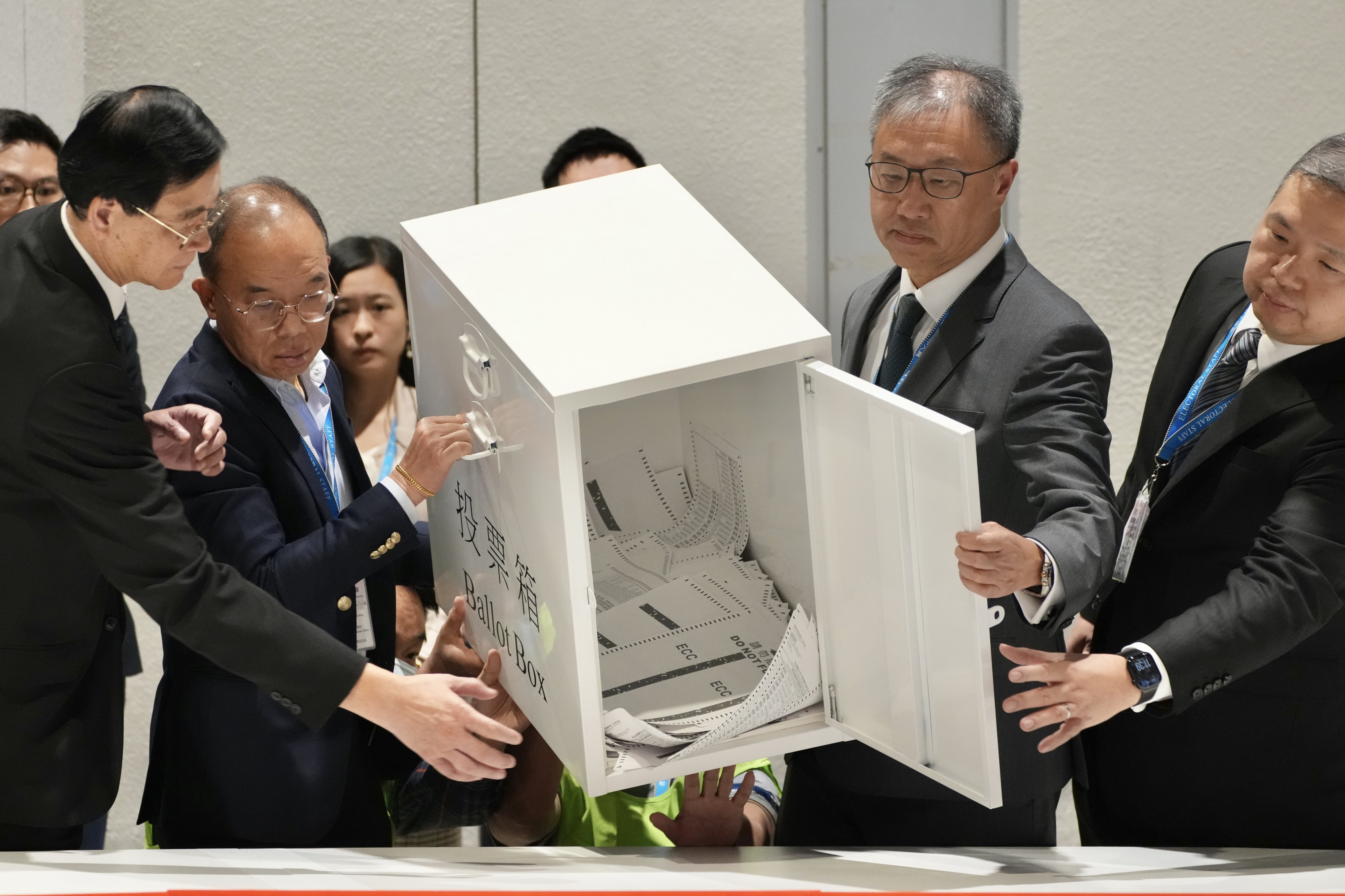Secretary for Constitutional and Mainland Affairs Erick Tsang (second from left) and chairman of the Electoral Affairs Commission David Lok (second from right) empty a ballot box during the last Legislative Council election in December 2025. Photo: Karma Lo