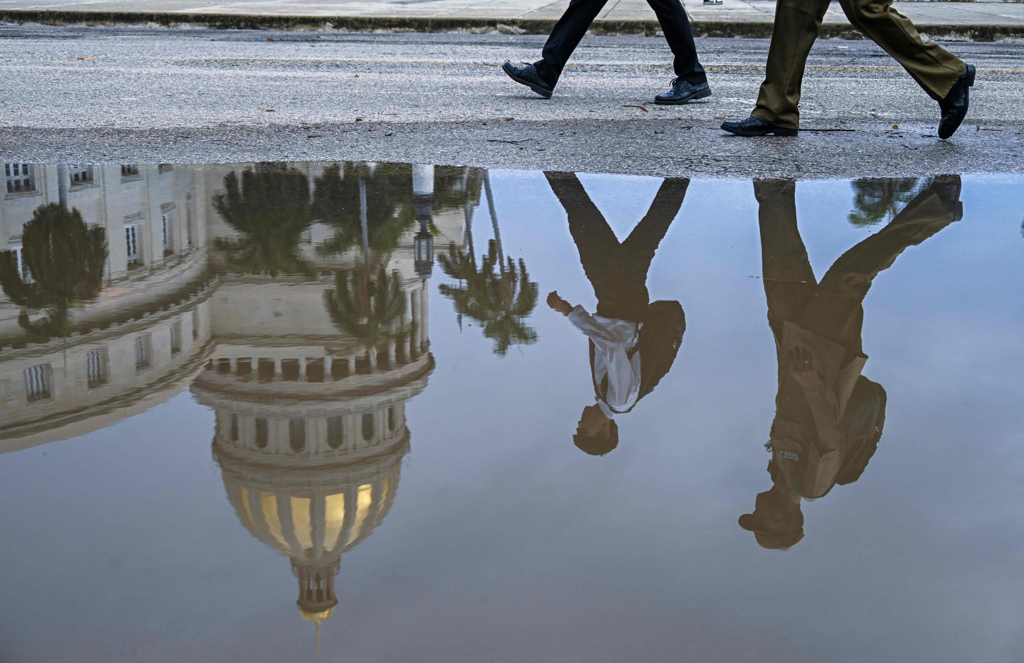 The Havana Capitol is seen reflected in a puddle on July 11. Photo: AFP