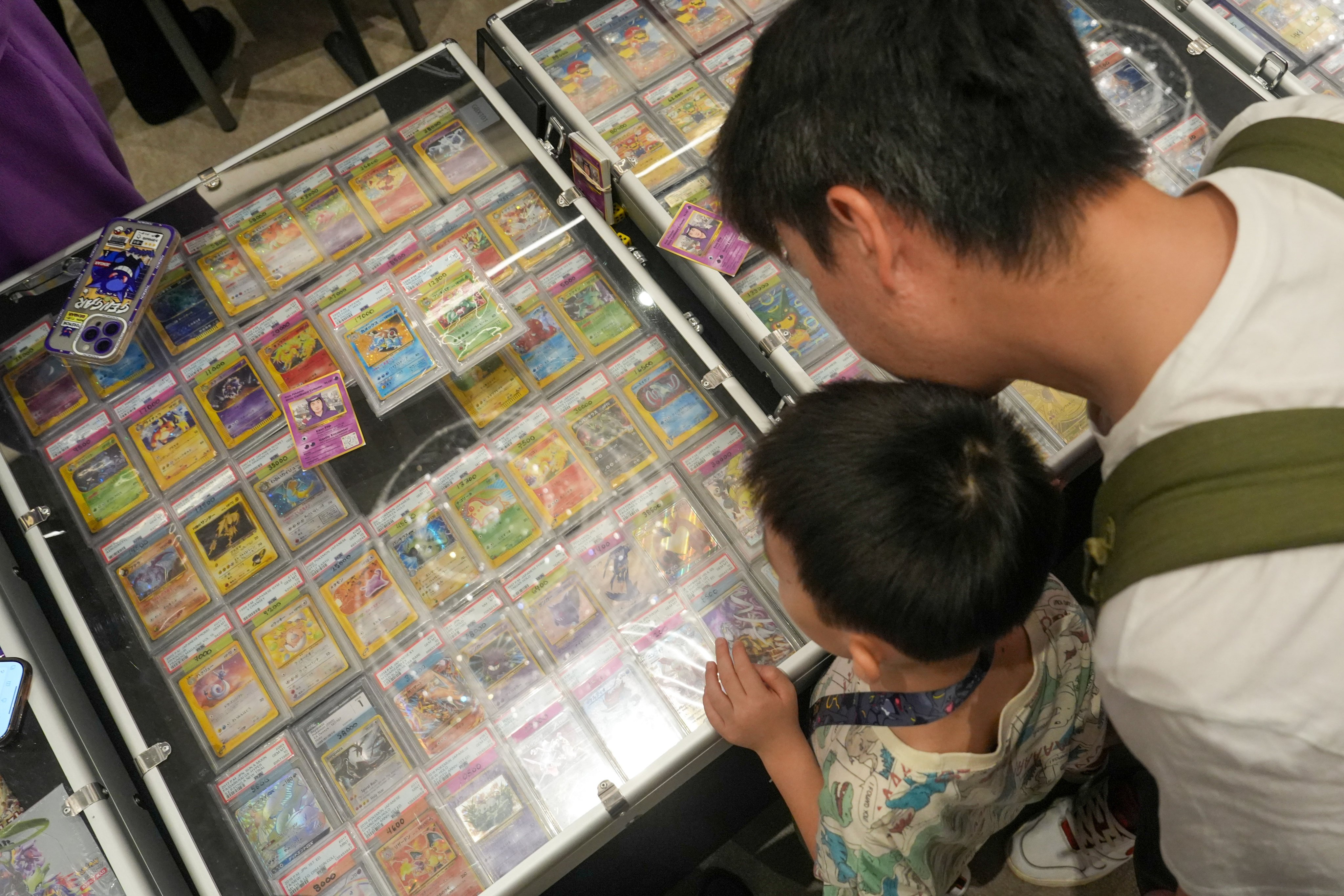 Visitors to Hong Kong’s Grade 10 Fest Summer 2026 in June look at trading cards on display. Photo: Sun Yeung