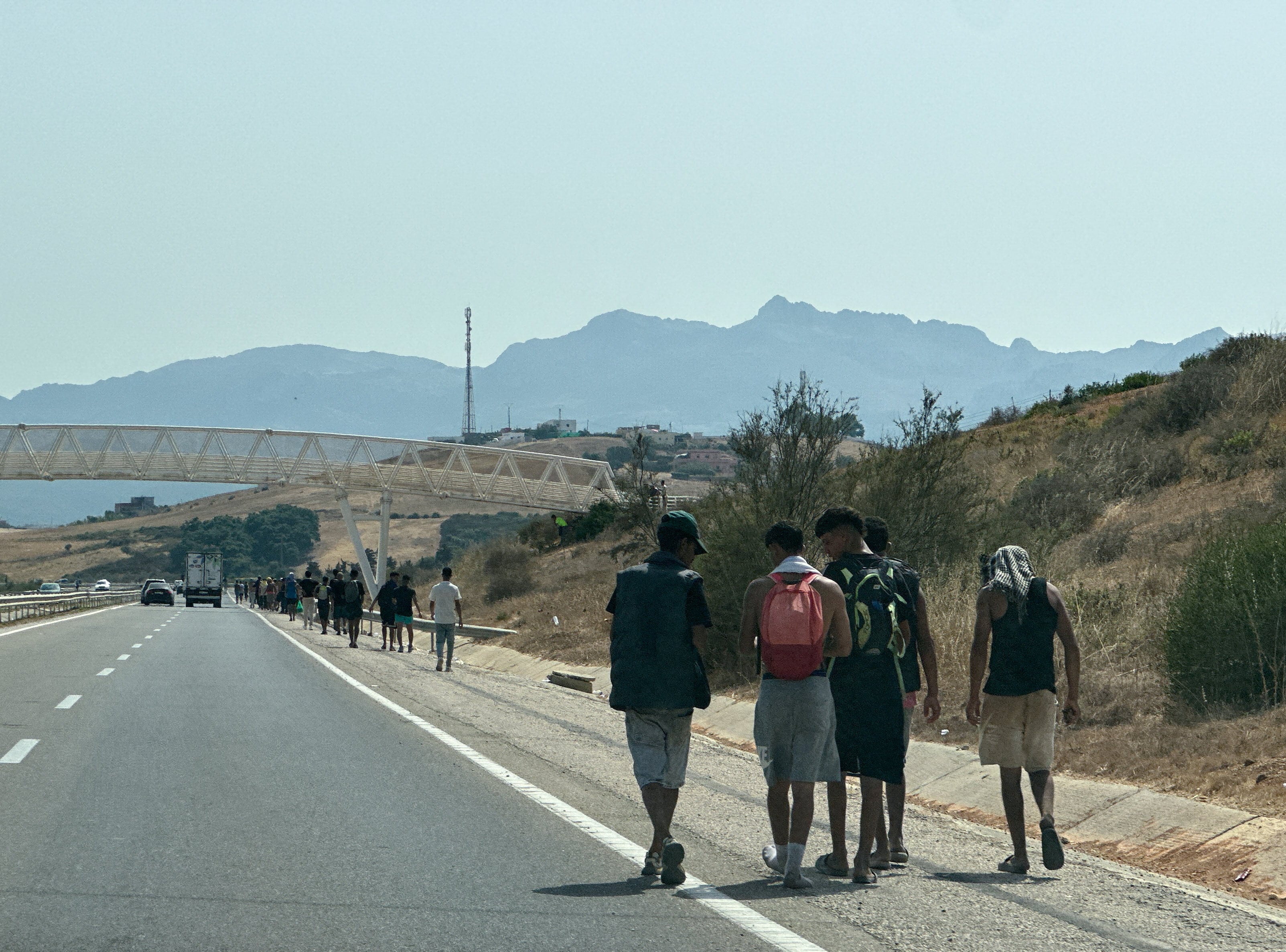Migrants walk back after crossing from Ceuta to the Moroccan side of the border in Fnideq on Friday. Photo: Reuters