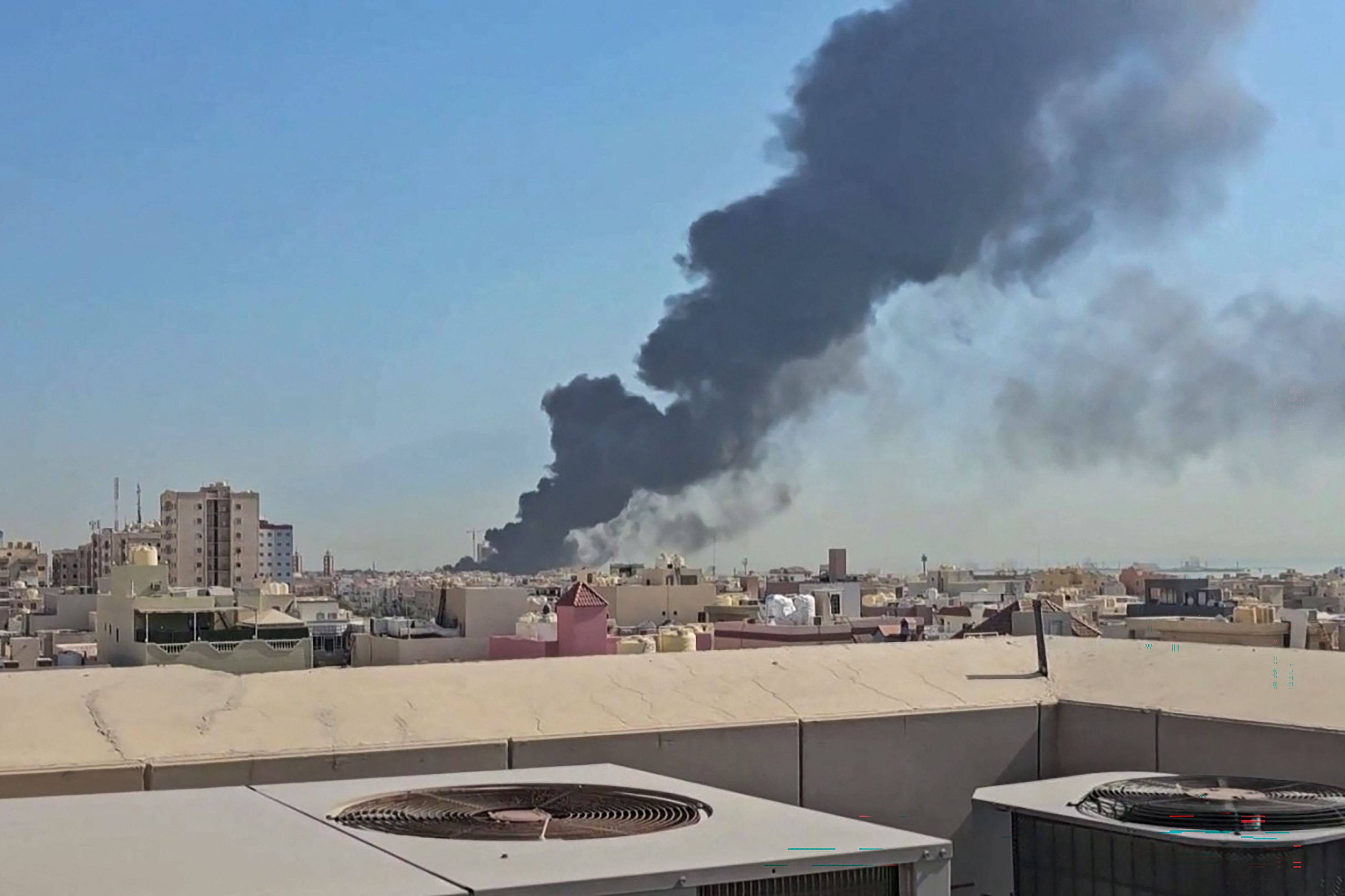 A plume of black smoke billowing over a town in Kuwait. The war in the Middle East has raised concerns about flying through the region, industry leaders say. Photo: AFP