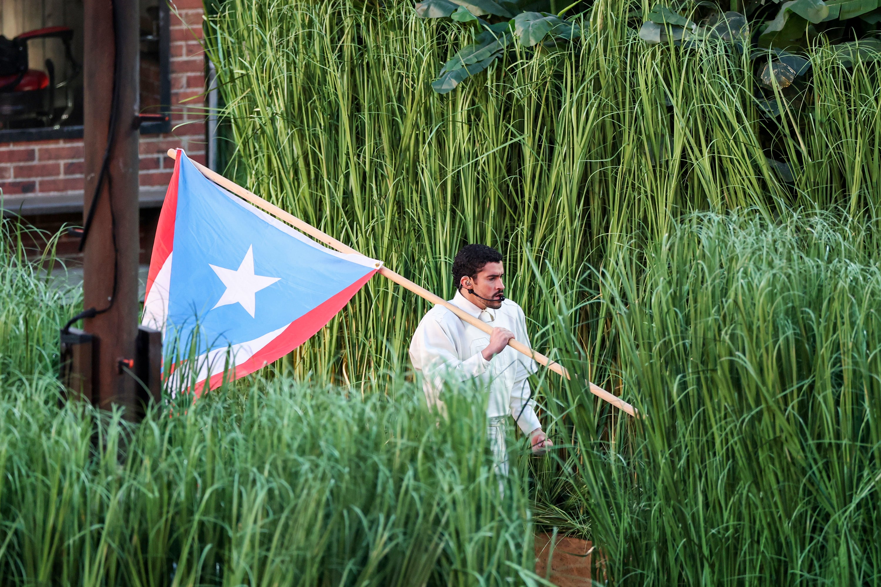 Bad Bunny carries a Puerto Rican flag for the Super Bowl halftime show in Santa Clara, California in February. Photo: The Seattle Times / TNS