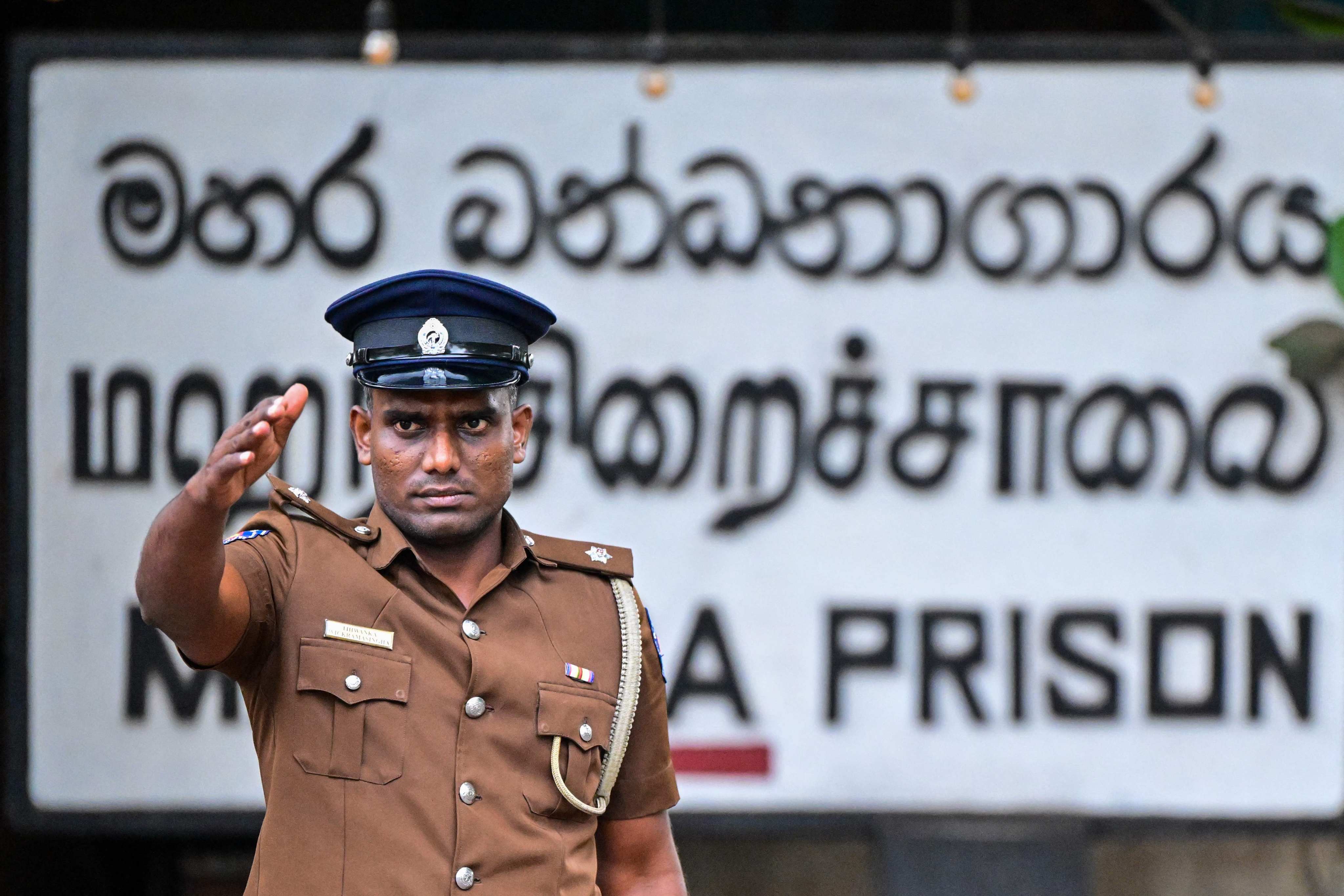 A police officer stands guard outside the Mahara Prison complex on Sunday. Photo: AFP