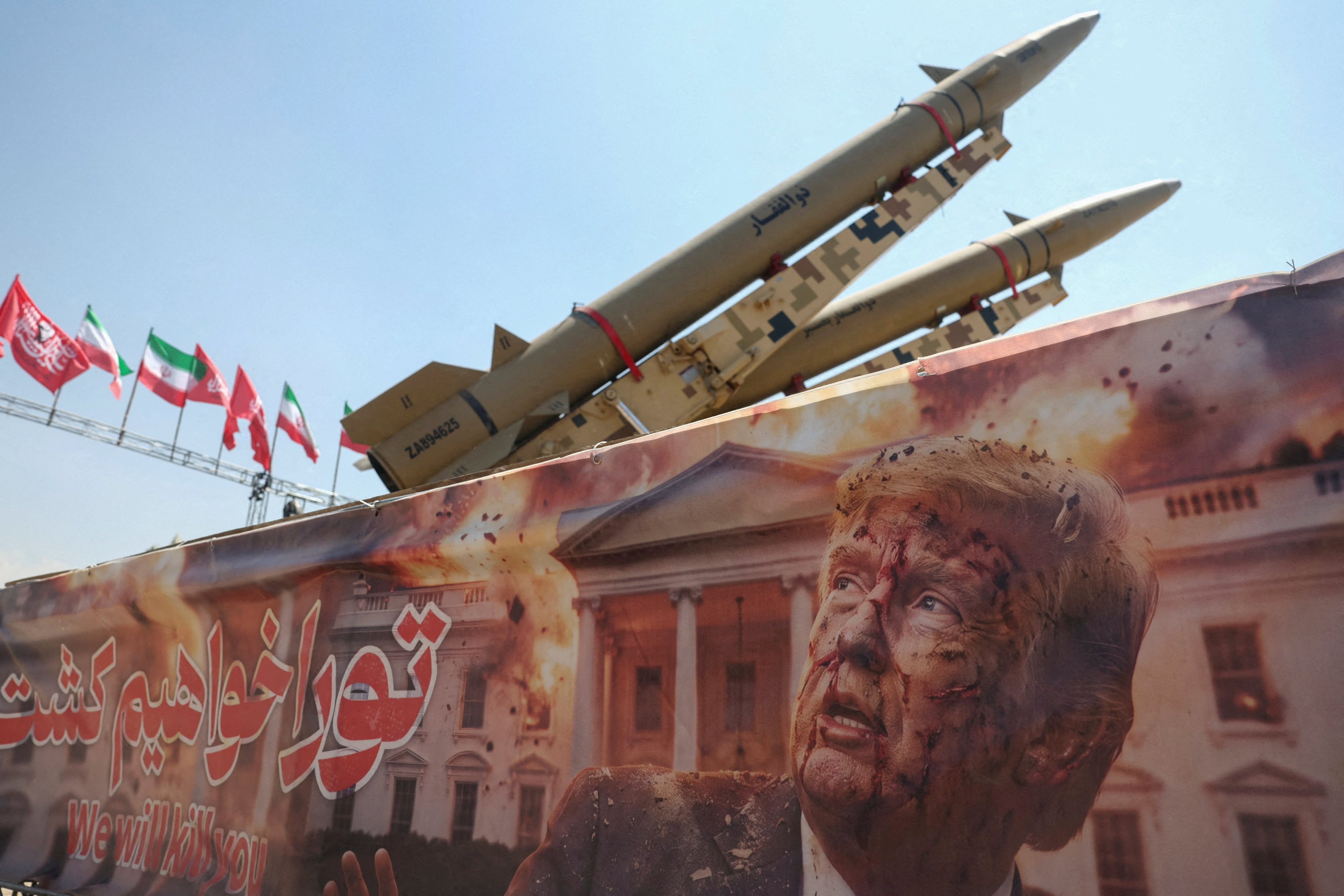 A banner featuring a picture of US President Donald Trump next to an Iranian missile battery at Azadi Square in Tehran on Thursday. Photo: WANA via Reuters