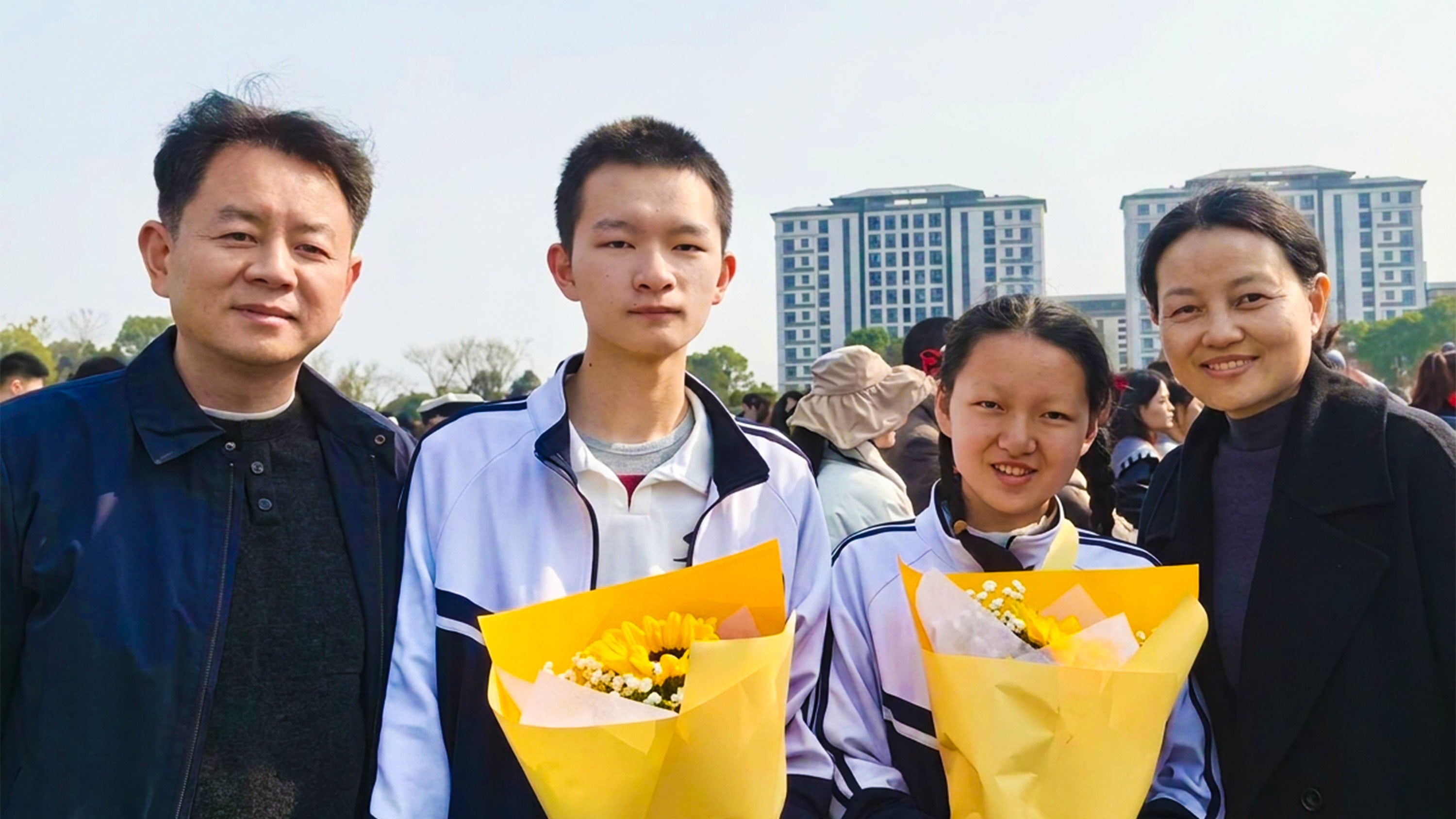 Chinese siblings celebrate their outstanding gaokao results with proud parents, marking a milestone achievement in their academic journey. Photo: The Paper