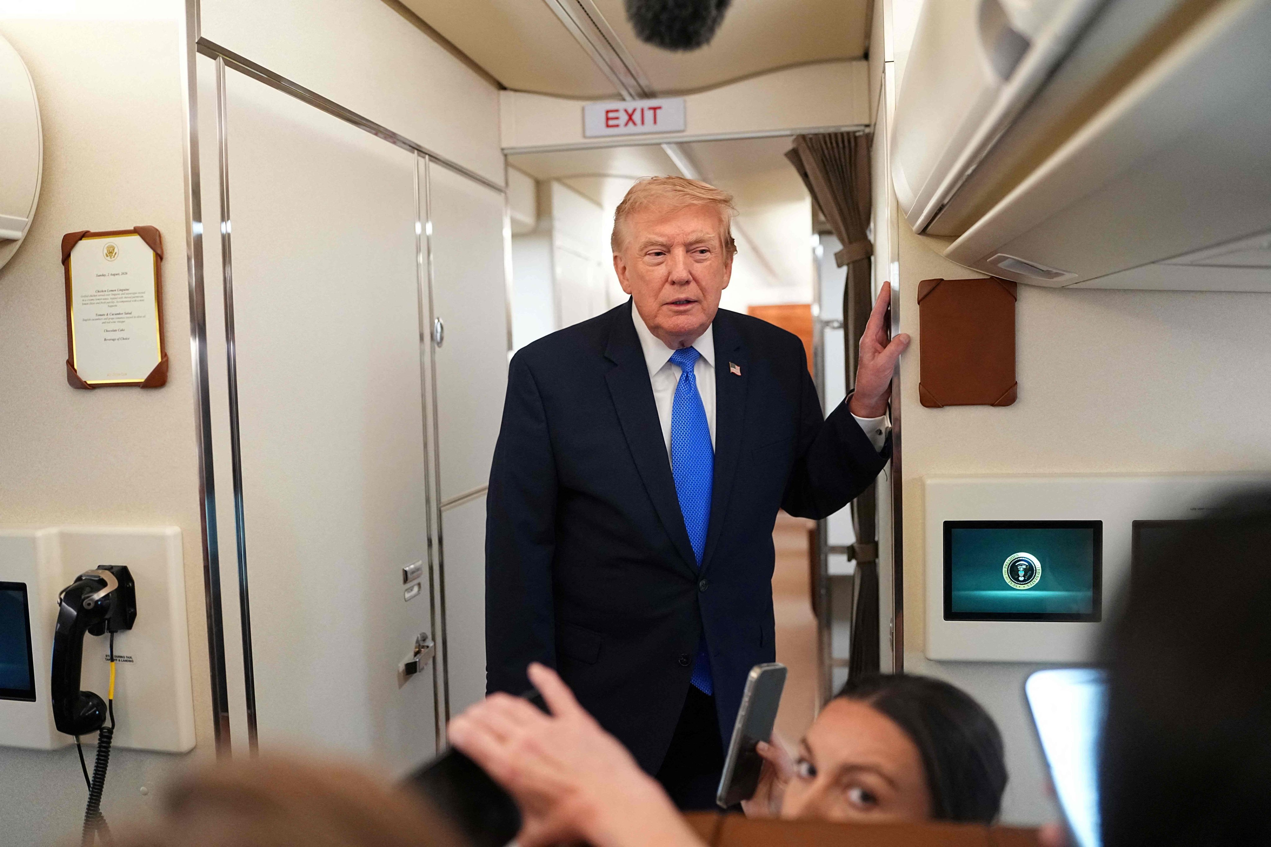 US President Donald Trump speaks to reporters aboard Air Force One on Sunday. Photo: AFP