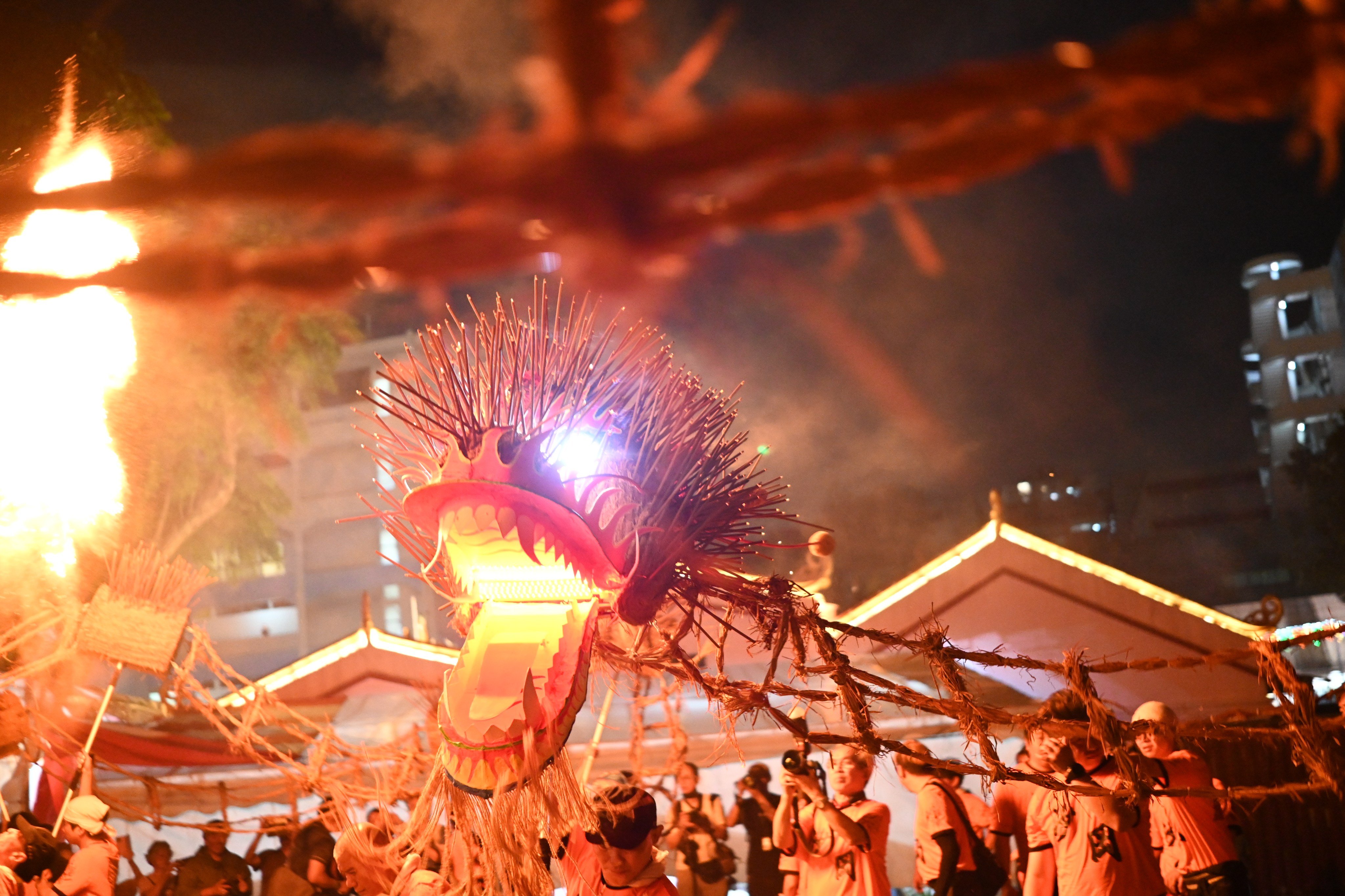 Spectators watch the Fire Dragon Dance of Sar Kong Mun San Fook Tuck Chee in March 2026. Every three years, the dragon is offered back to the deities through fire, reducing its physical form to ashes. This act is not an end but a renewal. Photo: Yeo GT