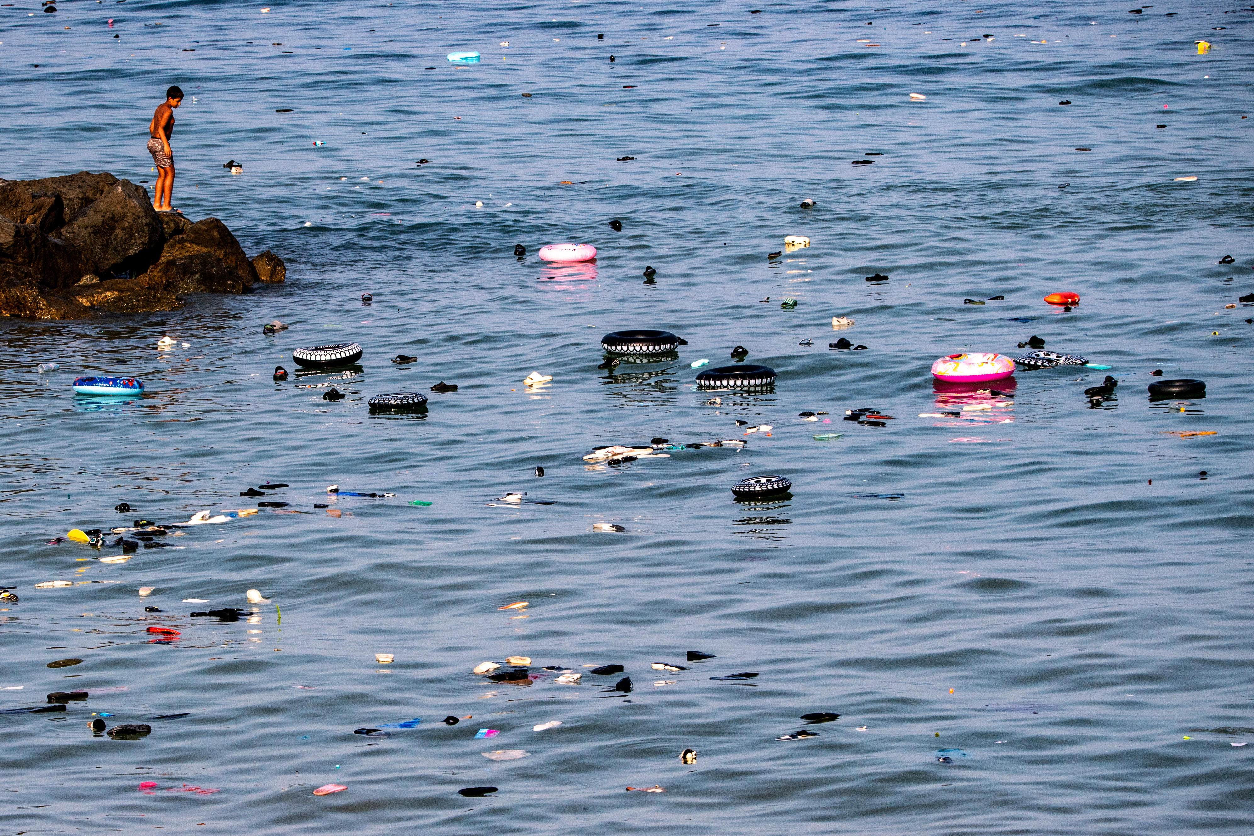 Belongings left behind by migrants float in the sea after they crossed from Morocco into Ceuta. Photo: AP