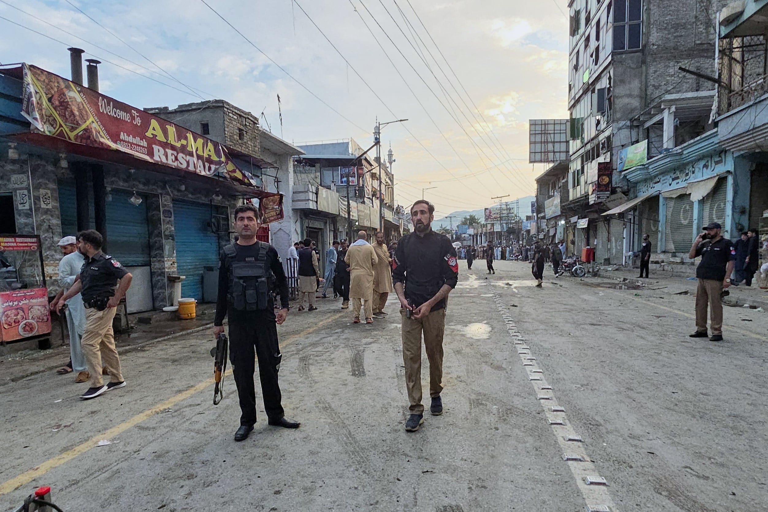 Police officers stand guard as others check the site following a suicide bombing in Kabal, Swat Valley in Pakistan’s Khyber Pakhtunkhwa province on Sunday. Photo: AP