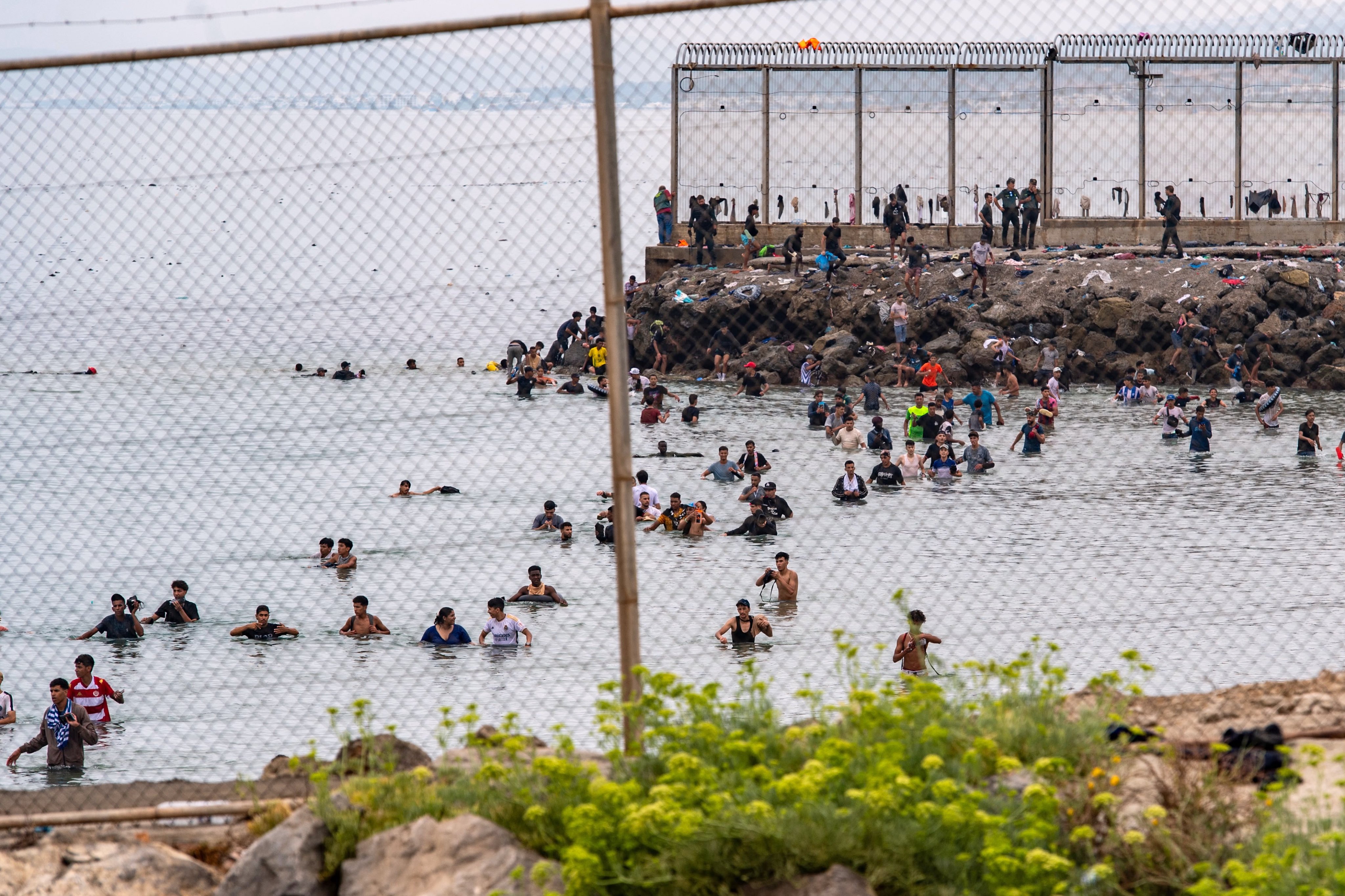 Migrants try to cross from Morocco into the Spanish enclave of Ceuta on Friday. Photo: AP