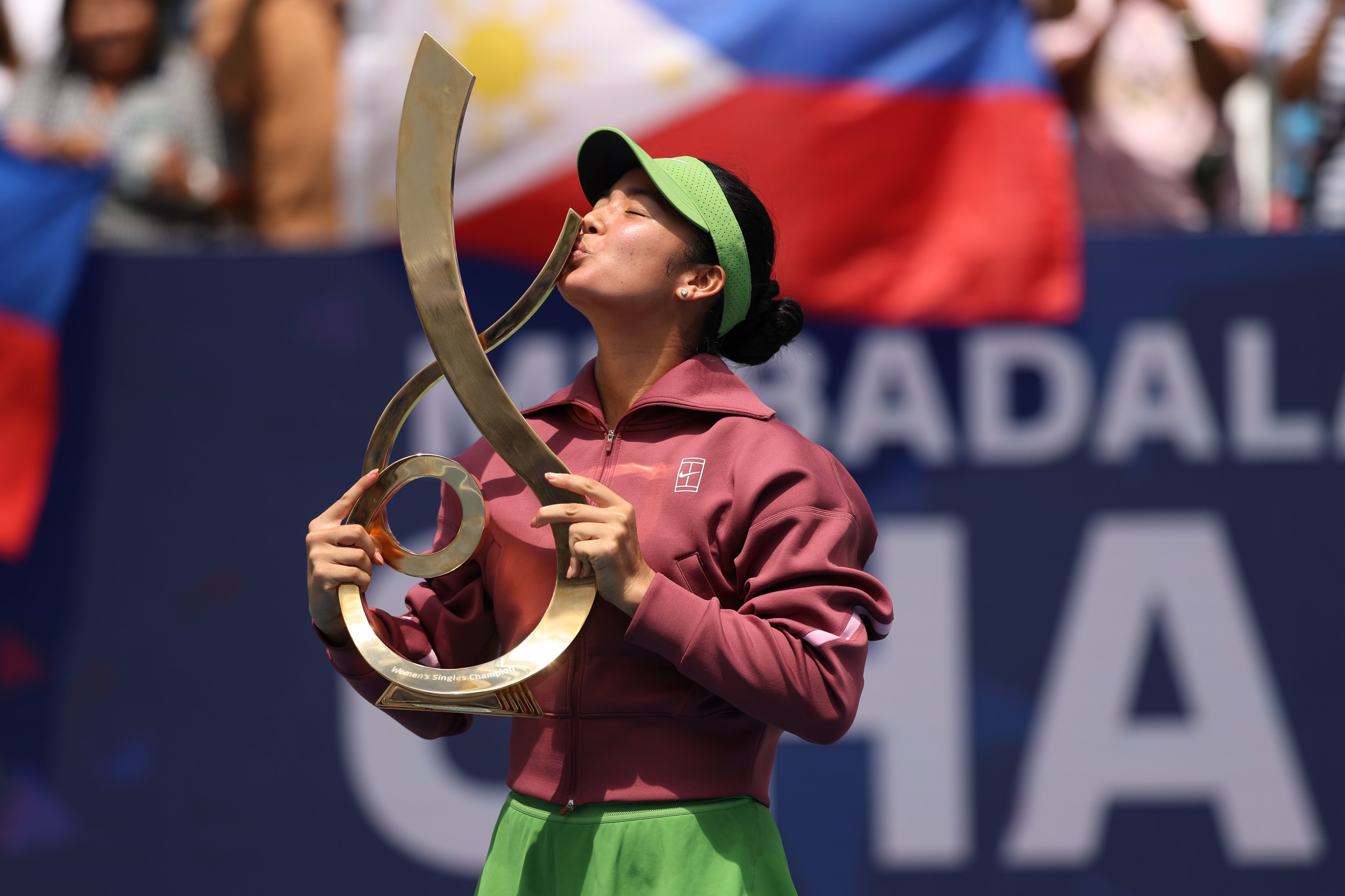 Aug 3, 2026; Washington, D.C., USA; Alexandra Eala (PHI) kisses the championship trophy during the trophy ceremony after her match against Jessica Pegula (USA) (not pictured) in the women's singles final of the 2026 Mubadala DC Open at Rock Creek Park Tennis Center. Mandatory Credit: Geoff Burke-Imagn Images