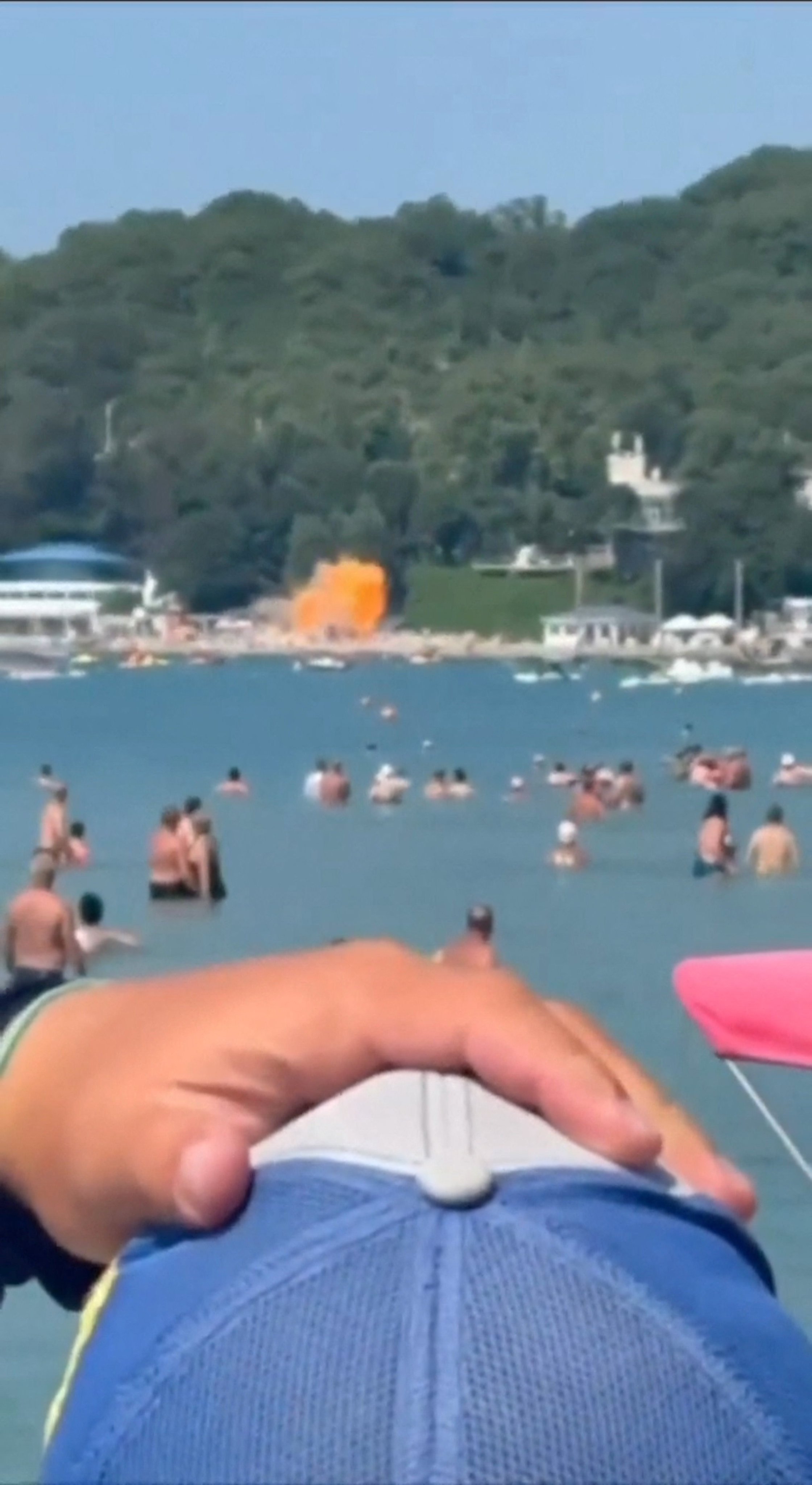 An image from social media footage shows an explosion on a busy beach at the holiday village of Arkhipo-Osipovka, as tourists look on. Photo: Social media via Reuters