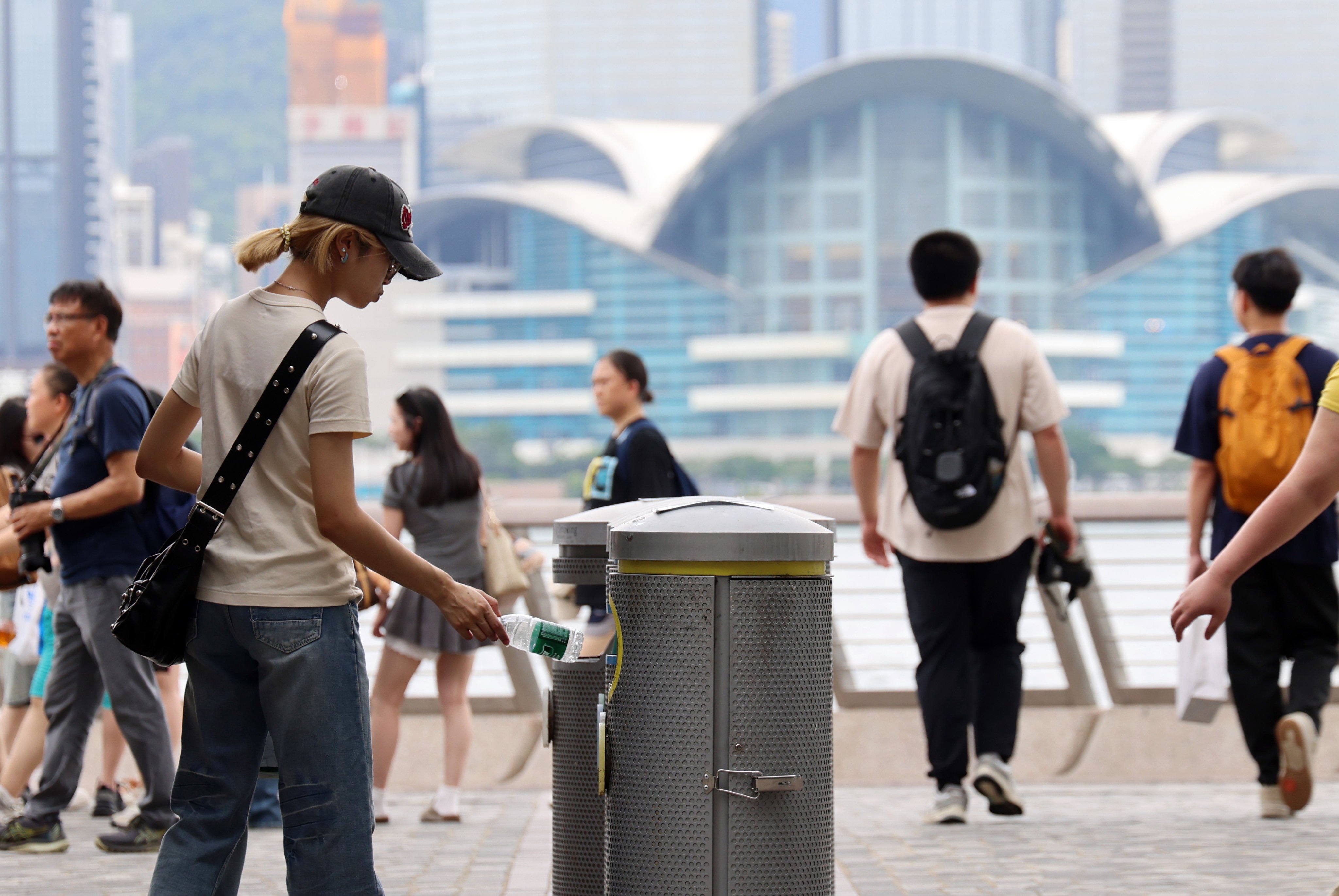A person throw a plastic bottle into a garbage bin in Tsim Sha Tsui. Photo: Jelly Tse