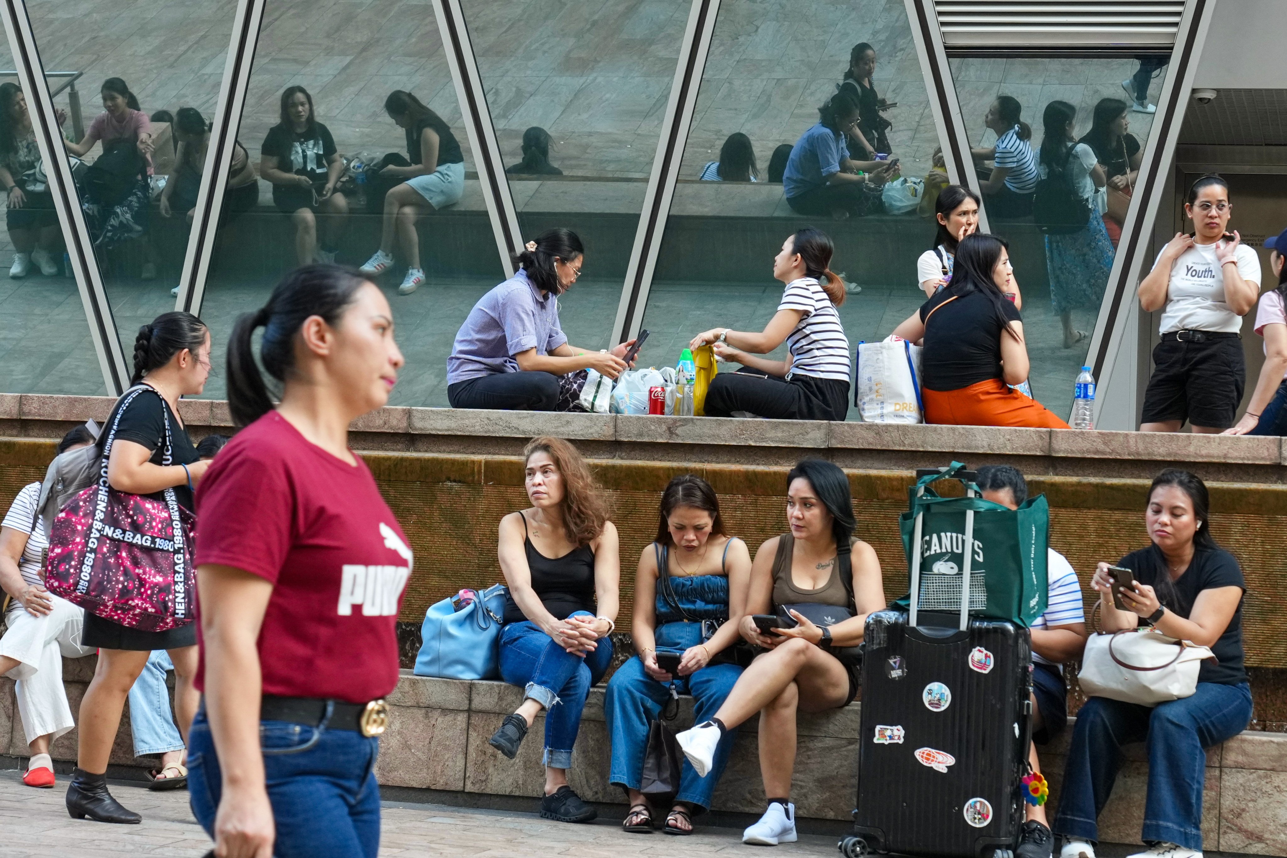 Domestic helpers gather in Central on their day off. Photo: Karma Lo