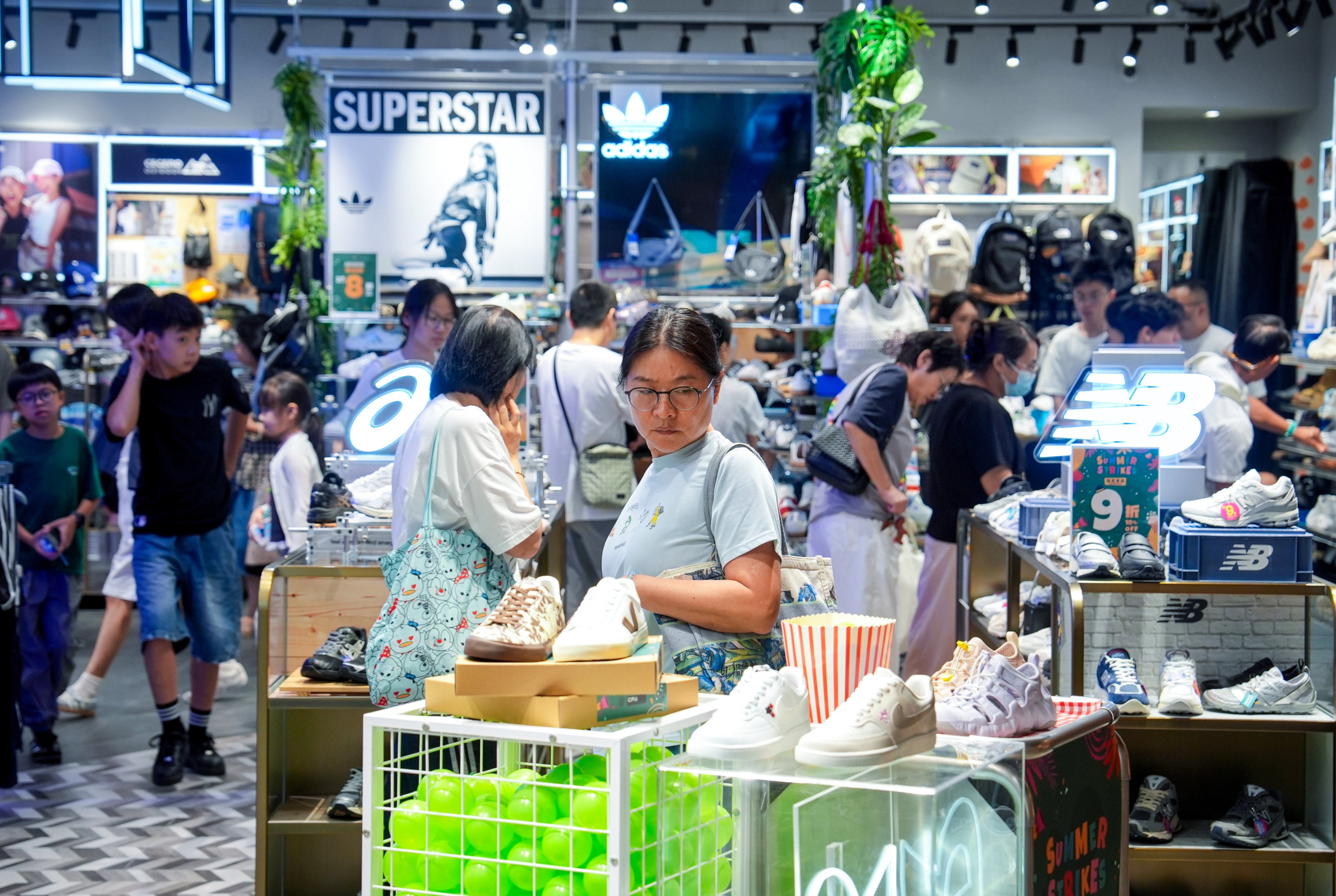 People shop at a sportswear store. Hong Kong’s economy grew by 5.1 per cent in the first half of the year. Photo: Elson Li