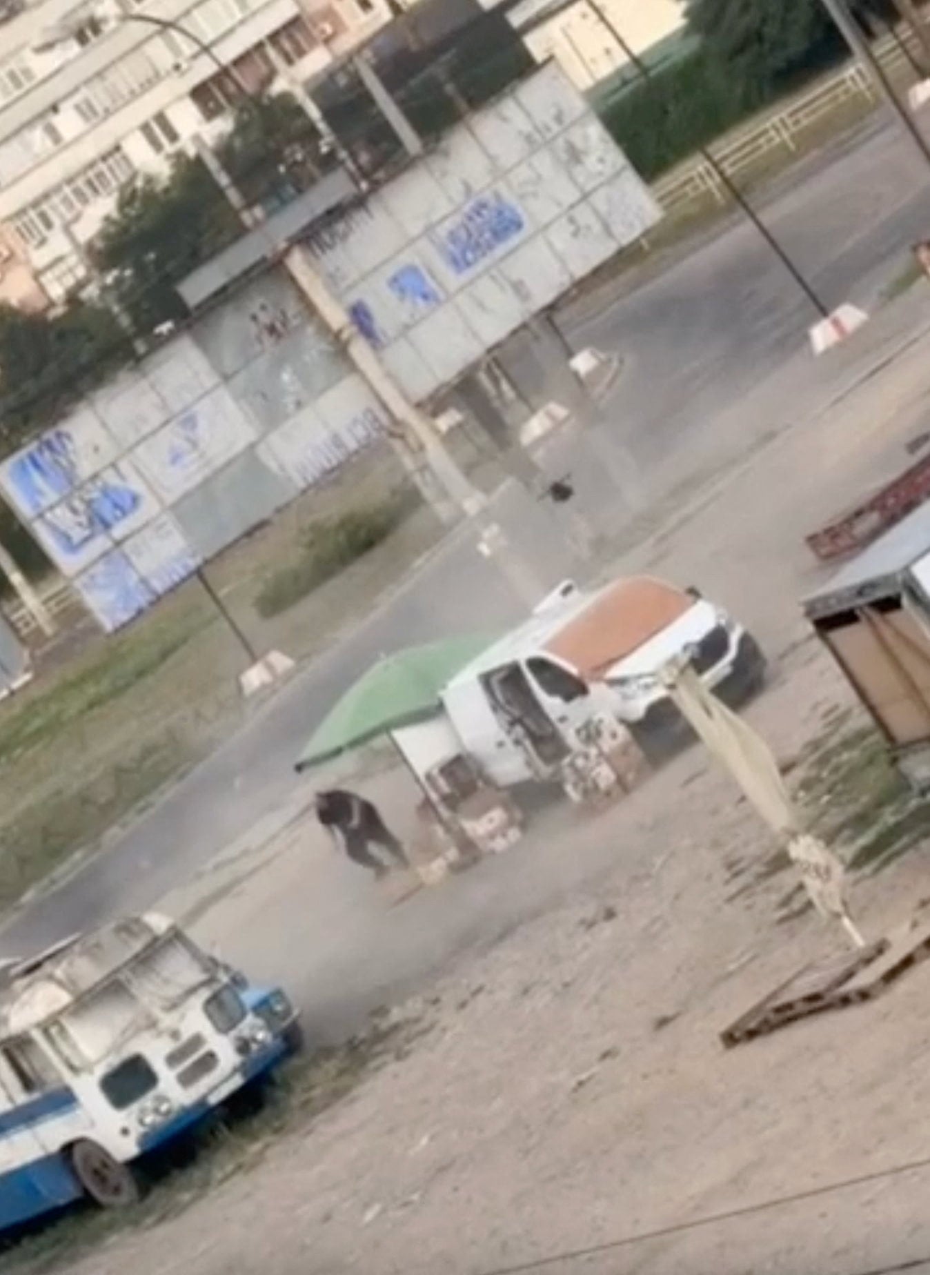 A drone circles over a man at a market in Kherson, Ukraine, before detonating nearby, in footage released on Tuesday. Photo: Kherson Regional Military Administration via Reuters