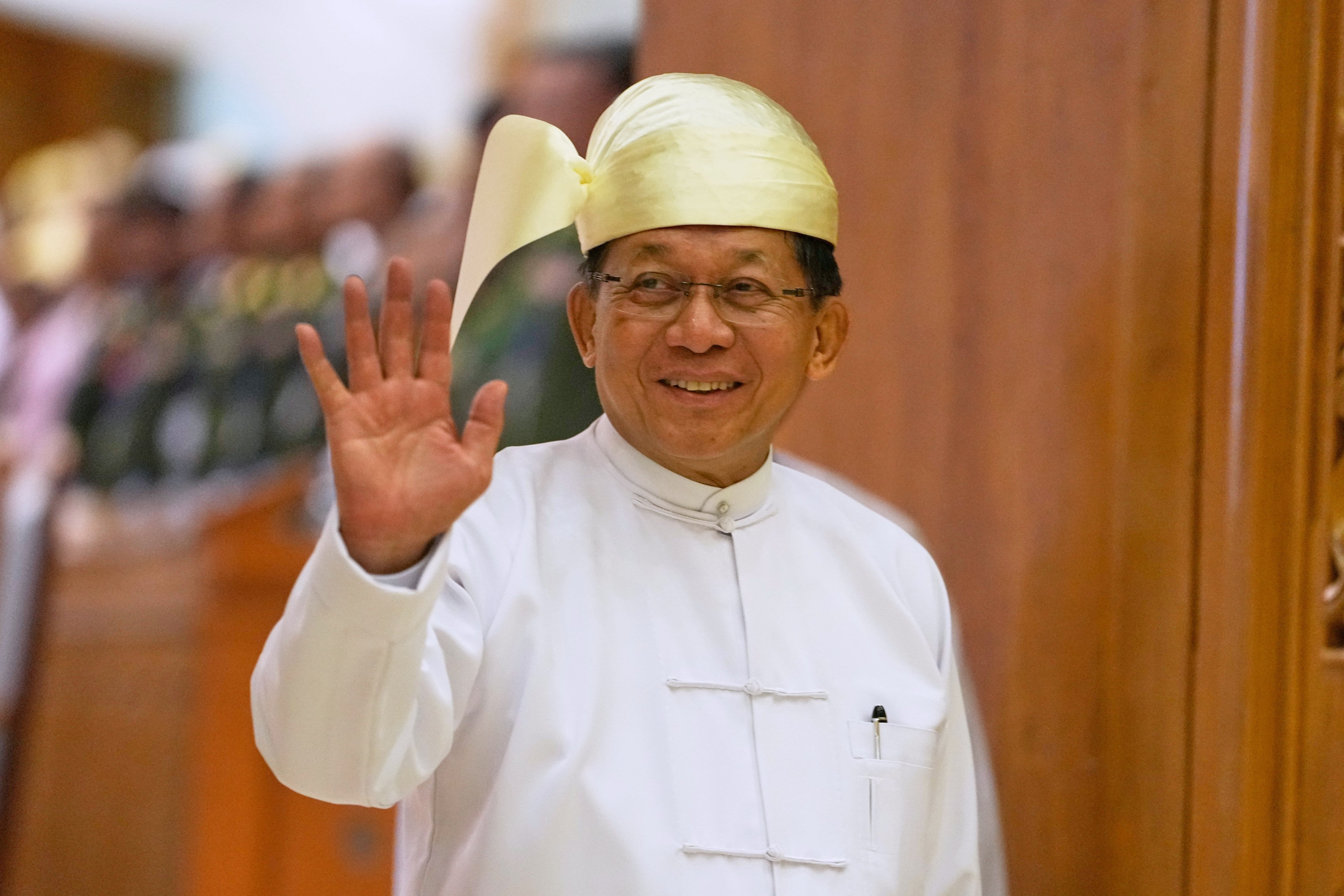 Myanmar President Min Aung Hlaing leaves after delivering a speech in parliament on Friday. Photo: AP
