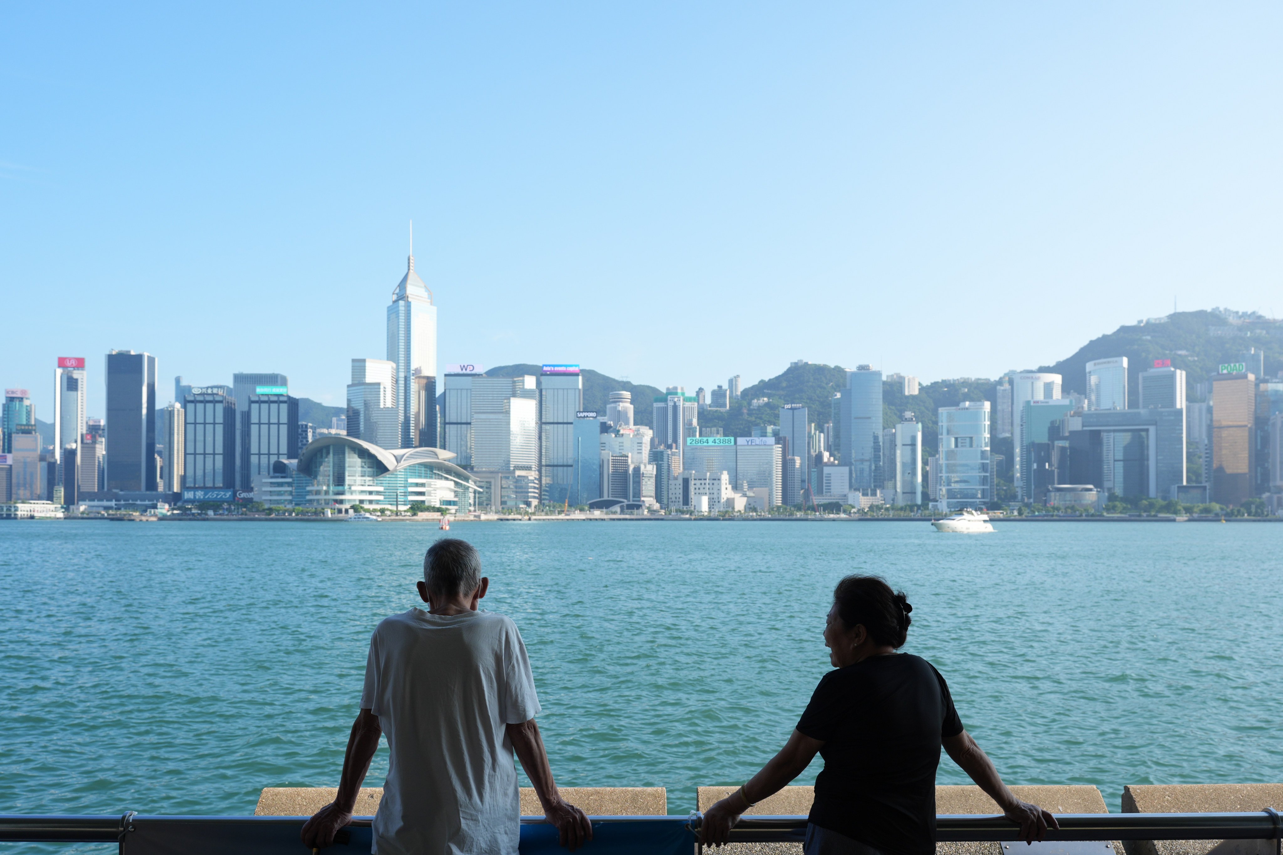 Elderly residents look out over the Tsim Sha Tsui waterfront in Hong Kong. Photo: SCMP/Eugene Lee