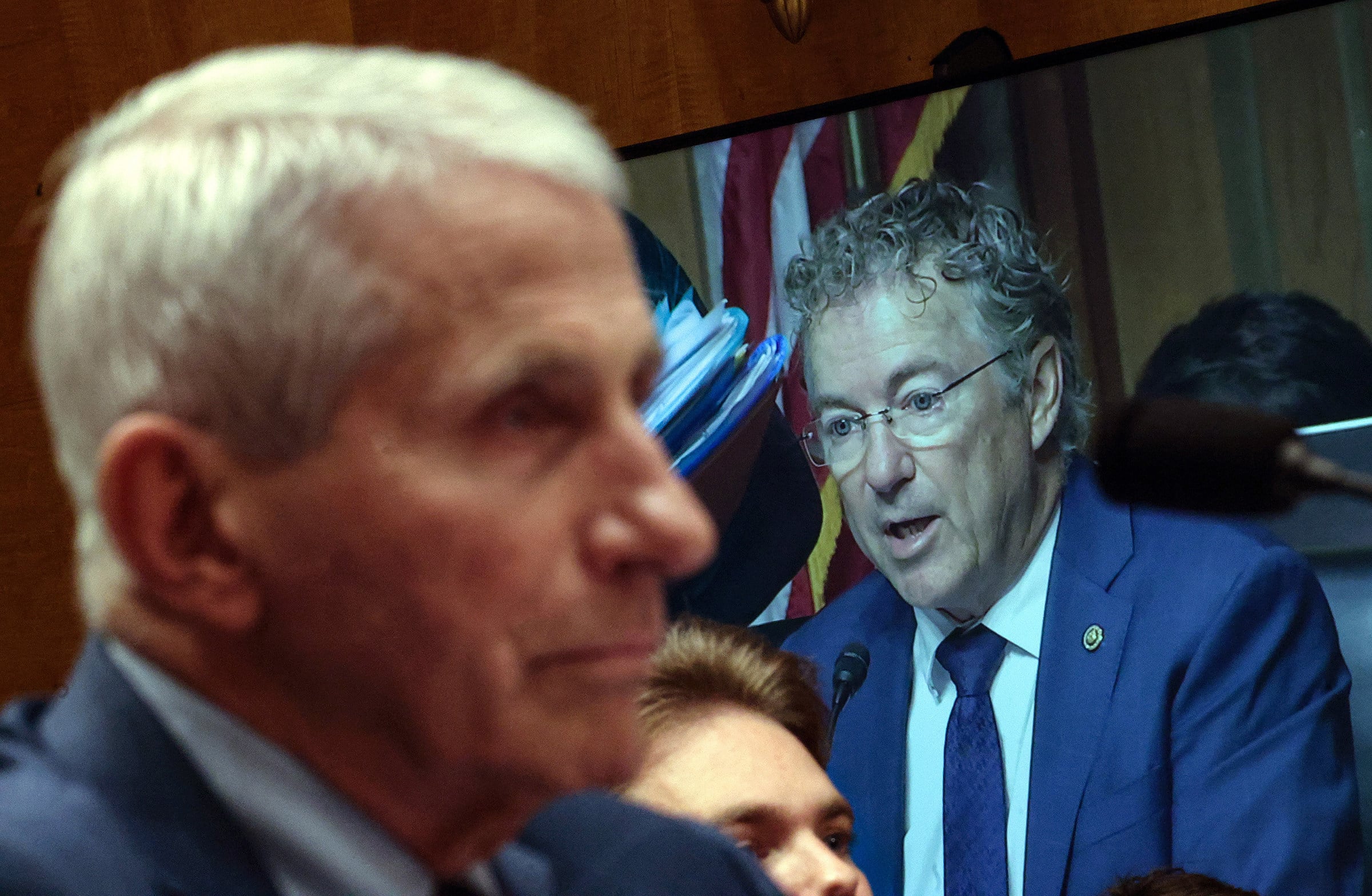 Committee Chairman US Senator Rand Paul is shown on a monitor as former NIH director Anthony Fauci (left) testifies before the Senate Homeland Security and Governmental Affairs Committee hearing on July 29 in Washington, DC. Photo: TNS