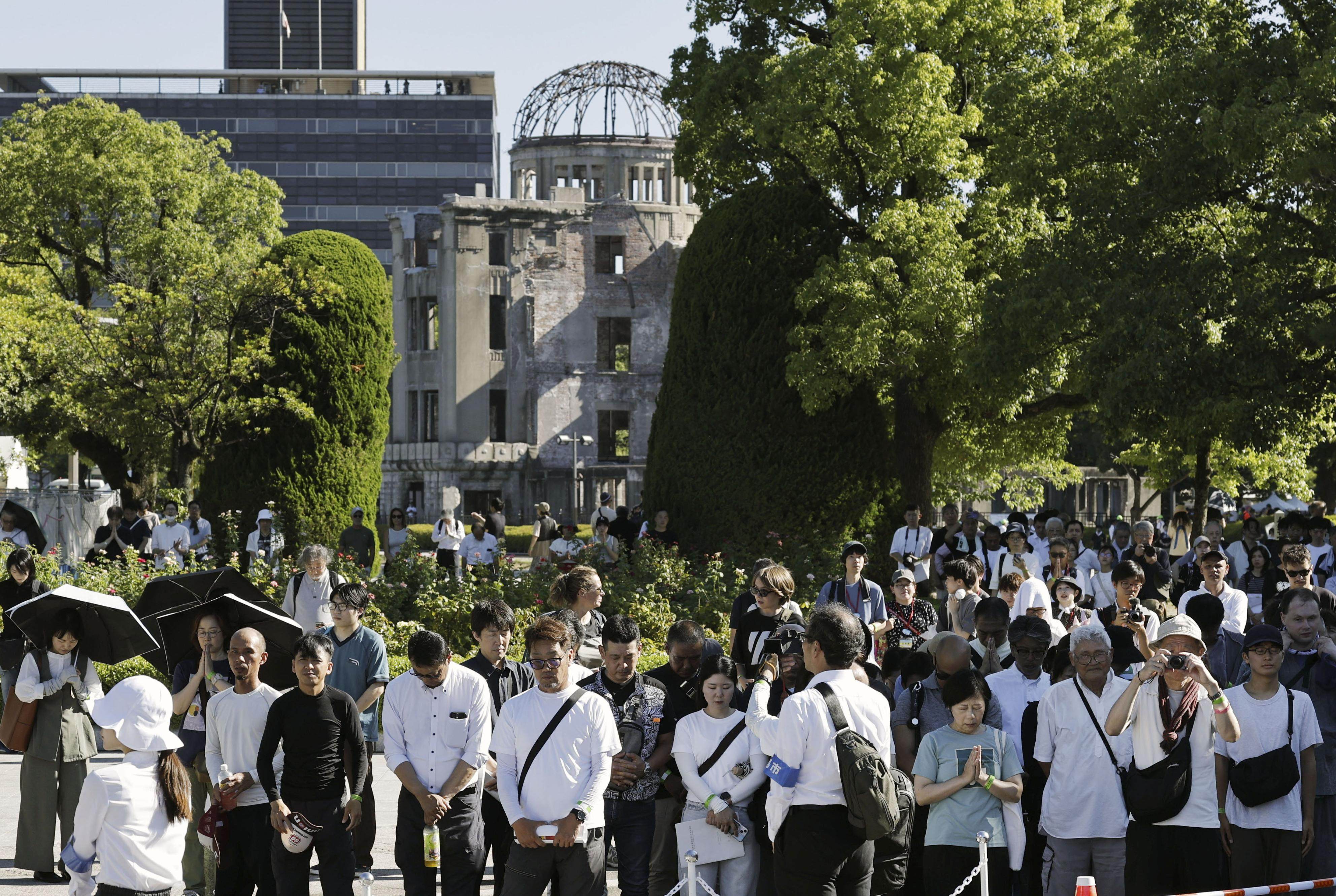 Visitors pray for the victims at the Hiroshima Peace Memorial Park, marking the anniversary of the US atomic bombing, in Hiroshima. Photo: Kyodo News via AP